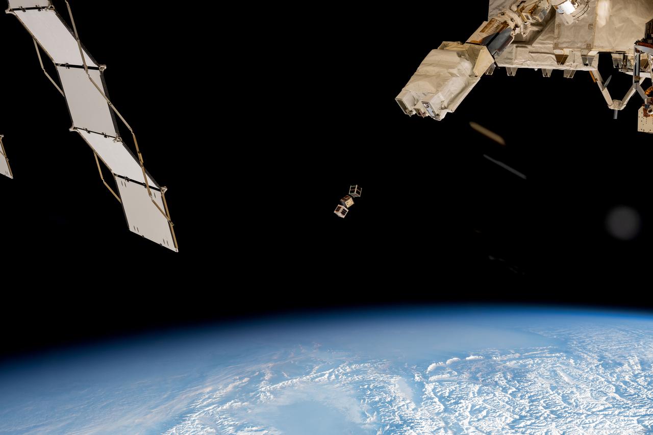 iss072e352045 (Dec. 9, 2024) --- A trio of CubeSats is ejected into Earth orbit from a small satellite orbital deployer attached to the International Space Station's Kibo laboratory module. A series of CubeSats were deployed into Earth orbit on Dec. 9, 2024, for educational research missions designed by Japanese high school and college students. Credit: NASA/Butch Wilmore