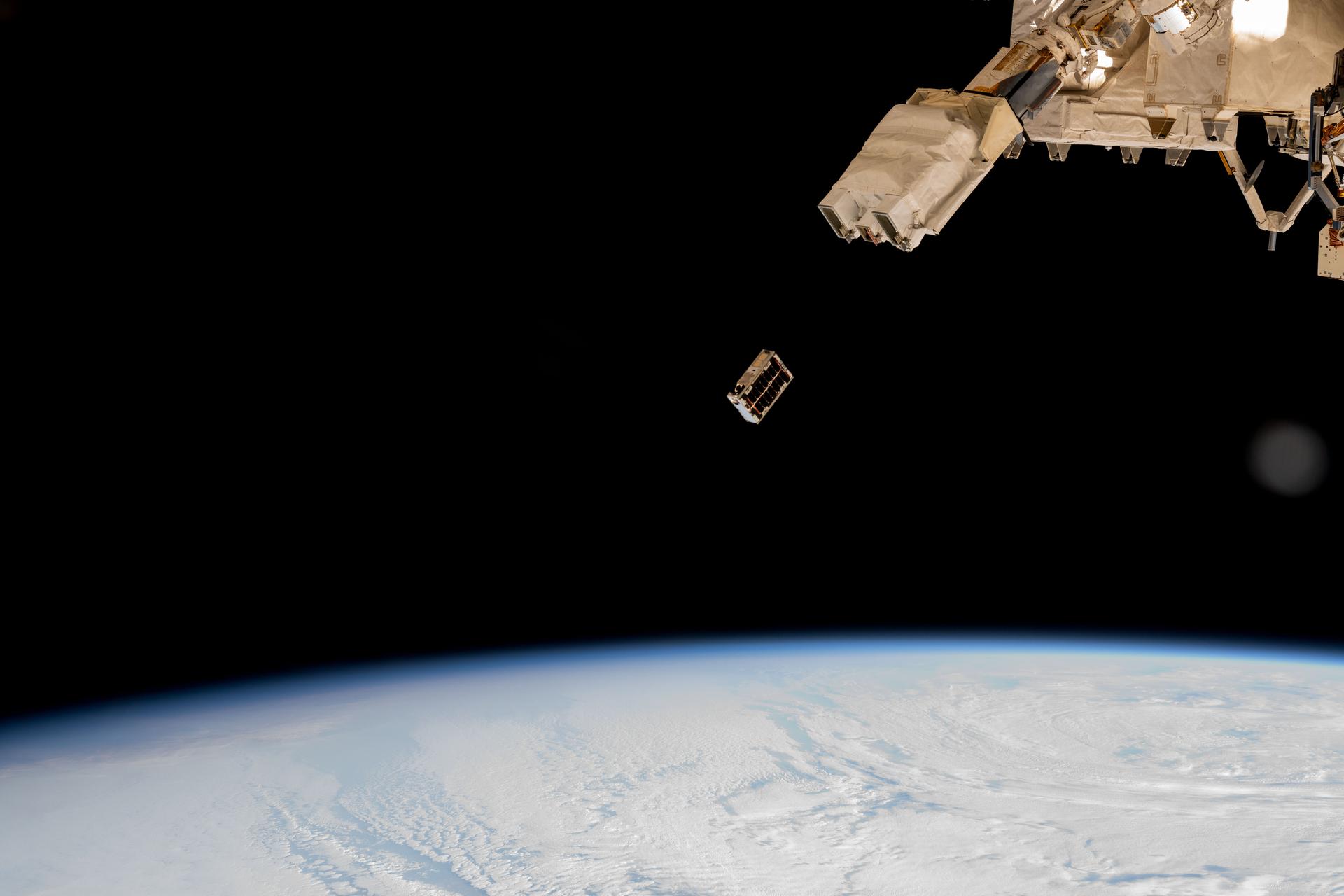 A CubeSat is ejected into Earth orbit from a small satellite orbital deployer attached to the International Space Station's Kibo laboratory module. A series of CubeSats were deployed into Earth orbit on Dec. 9, 2024, for educational research missions designed by Japanese high school and college students.