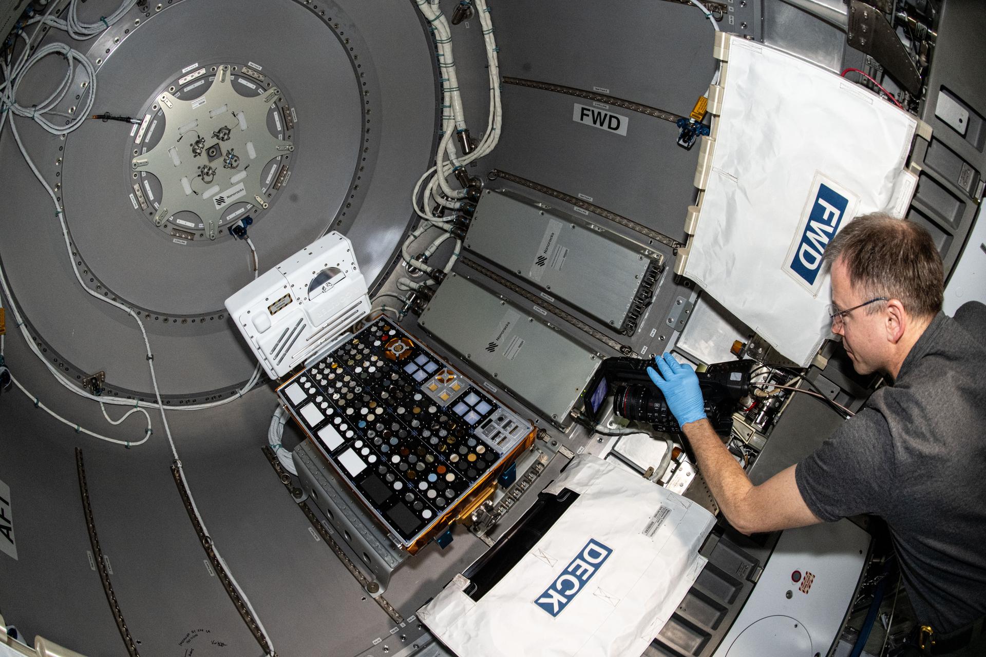 NASA astronaut and Expedition 72 Flight Engineer Nick Hague installs the European Materials Ageing experiment hardware inside the Nanoracks Bishop airlock. The external investigation will be robotically removed from Bishop, installed on the Bartolomeo research platform attached to the outside of the Columbus laboratory module, and expose a variety of materials to the vacuum of space for about a year.