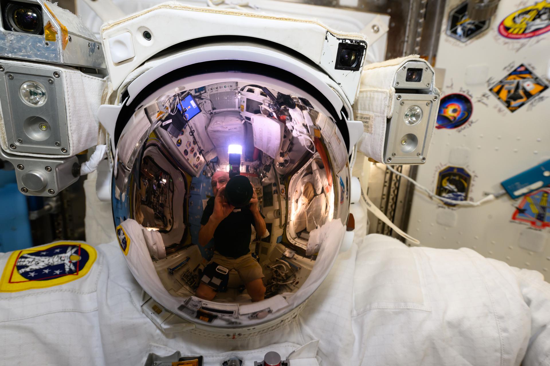 NASA astronaut and Expedtion 72 Flight Engineer Don Pettit took this photograph of a U.S. spacesuit helmet with his reflection prominent on the helmet's visor inside the International Space Station's Quest airlock.