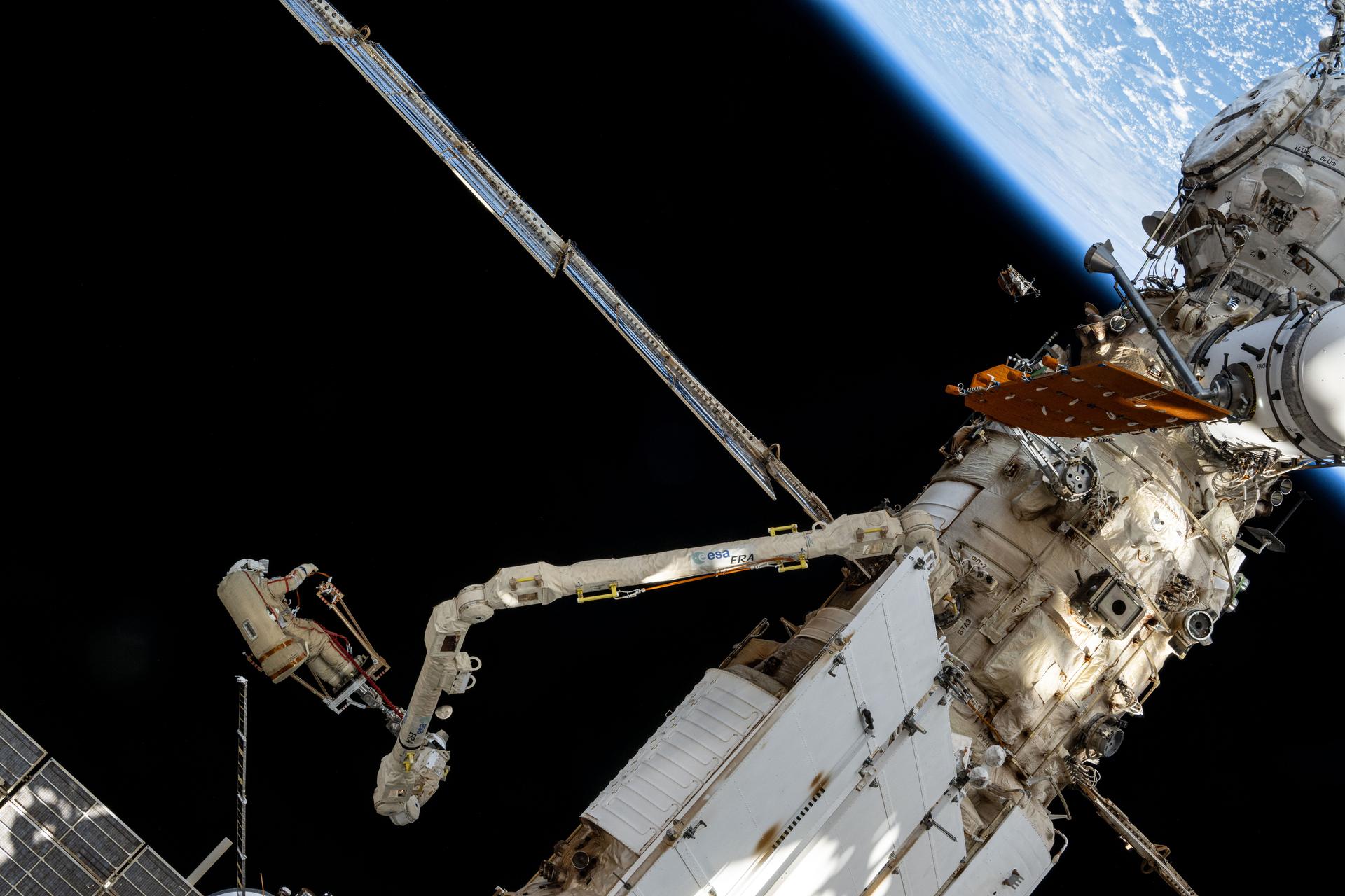 Roscosmos cosmonaut and Expedition 72 Flight Engineer Alexey Ovchinin is maneuvered using the European robotic arm during a seven-hour and 17-minute spacewalk. He and fellow Flight Engineer Ivan Vagner (not pictured) partnered together in the vacuum of space on Dec.19 installing a celestial X-ray experiment and removng other scientific hardware on the exterior of the International Space Station.