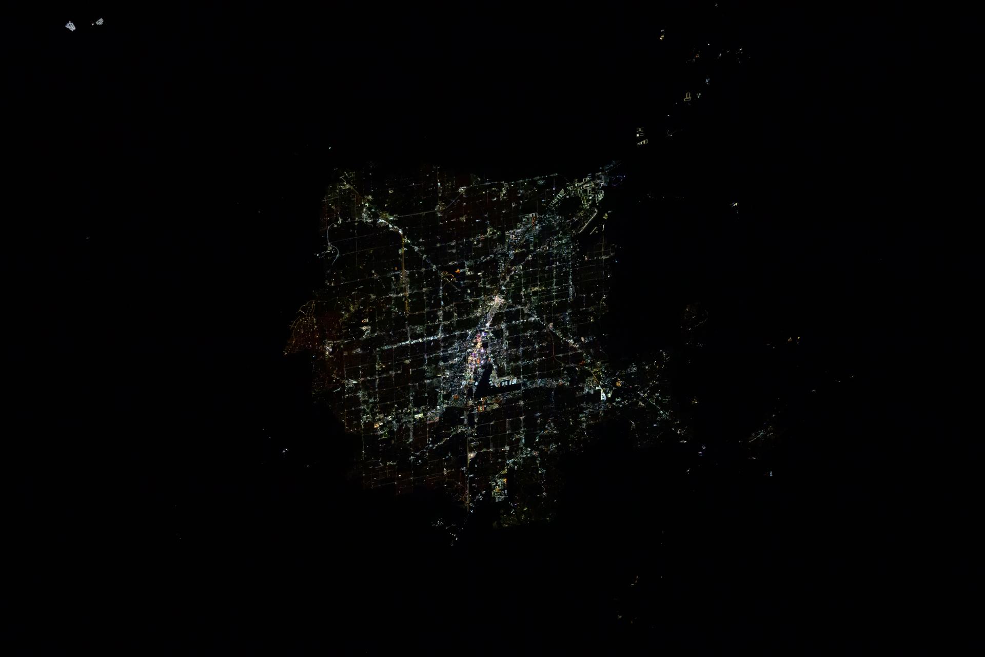 Downtown Las Vegas, Nevada, with its famous well-lit strip and Harry Reid International Airport at center, is pictured at approximately 4:16 a.m. local time from the International Space Station as it orbited 256 miles above.