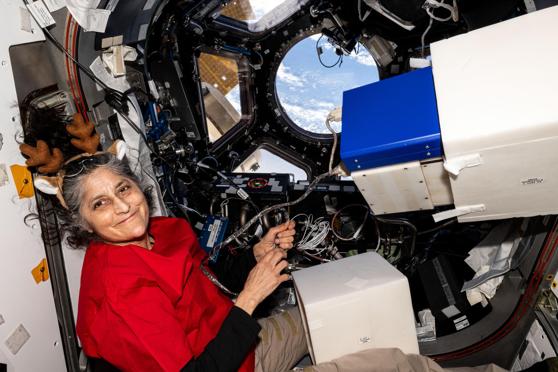 NASA astronaut and Expedition 72 Commander Suni Williams assembles research hardware inside the International Space Station's cupola while orbiting 261 miles above the Pacific Ocean west of Nicaragua.