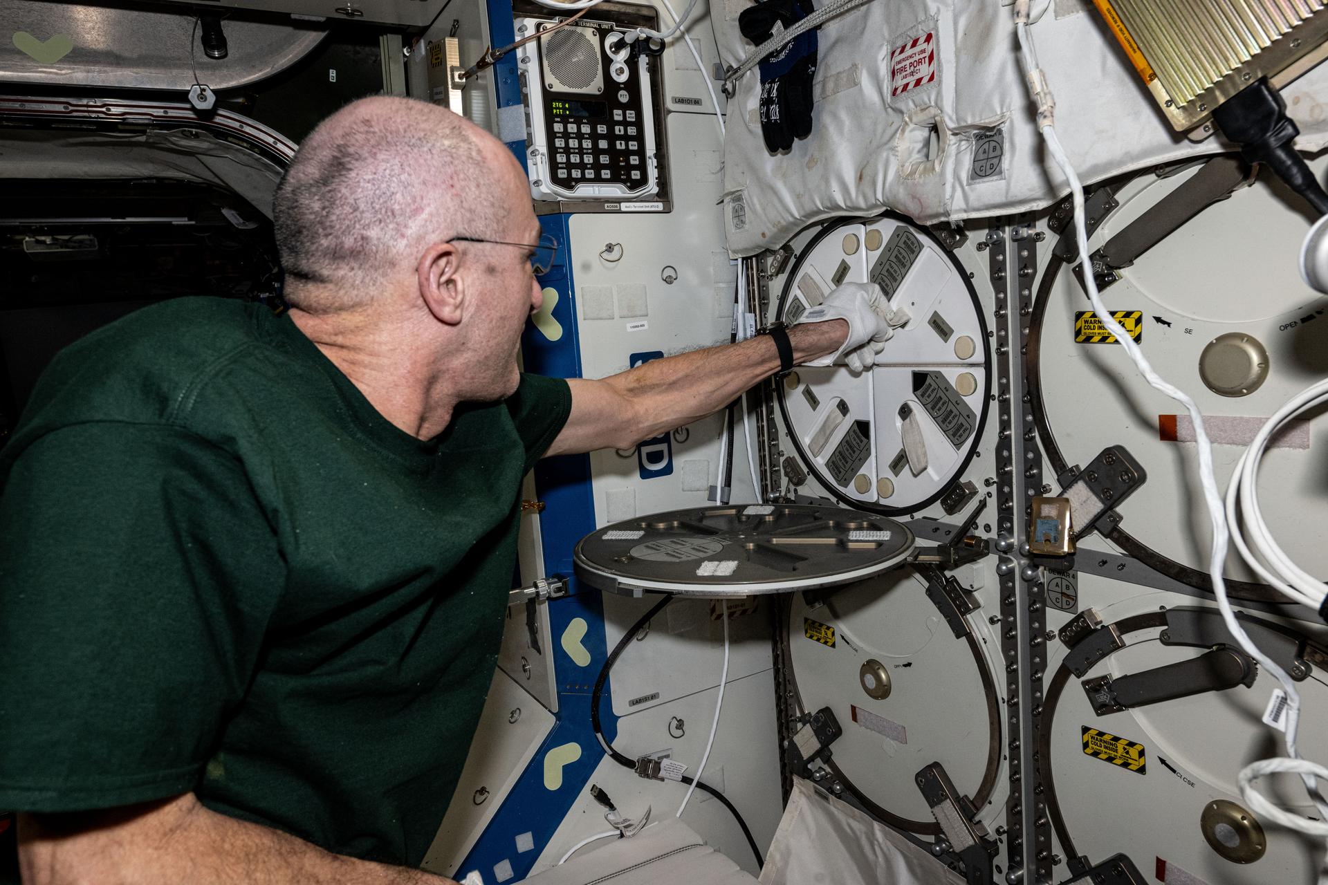 NASA astronaut and Expedition 72 Flight Engineer Don Pettit stows plant samples inside a science freezer aboard the International Space Station's Destiny laboratory module. Also called MELFI, or the Minus Eighty-Degree Laboratory Freezer for ISS, the cold stowage research device preserves experiment samples at ultra-cold temperatures in microgravity for later return to Earth and analysis.