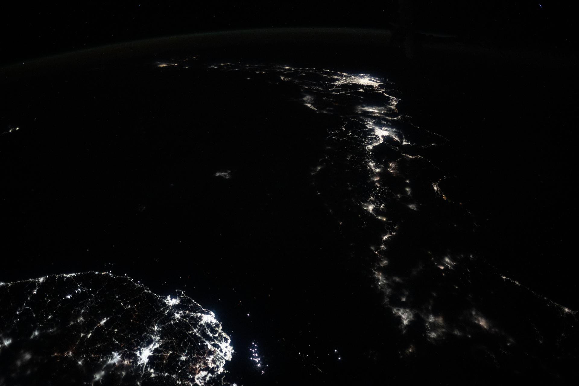 The Korea Strait separates Busan, Korea (bottom left), and Fukuoka, Japan, in this photograph taken approximately 12:55 a.m. local time from the International Space Station as it orbited 258 miles above the Korean coast. Toward the top right, are the city lights of Osaka, Nagoya, and Tokyo.