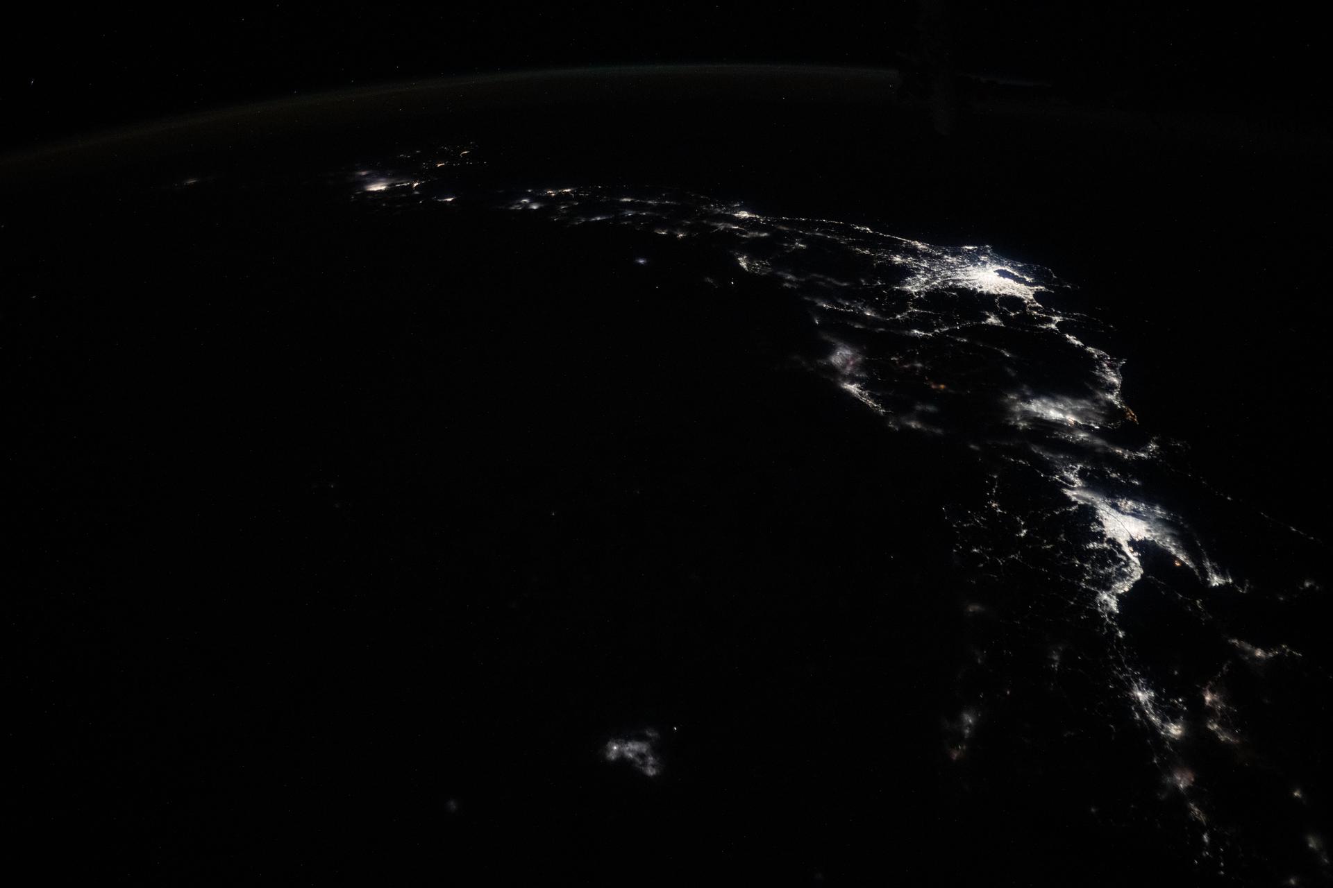 The city lights of Osaka, Nagoya, and Tokyo on the island nation of Japan highlight this photograph taken approximately 12:55 a.m. local time from the International Space Station as it orbited 258 miles above the Sea of Japan.