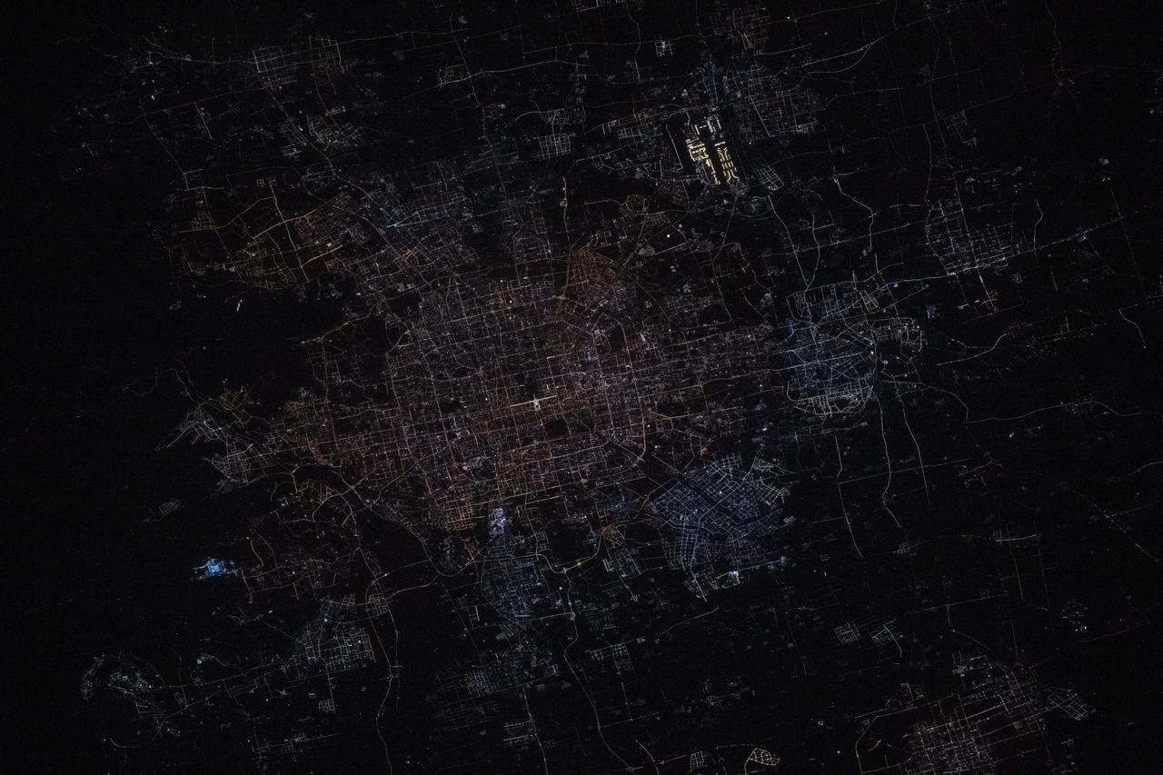 iss072e444944 (Dec. 28, 2024) --- Beijing, China's capital city with a population of about 21.9 million residents, is pictured at approximately 1:31 a.m. local time from the International Space Station as it orbited 259 miles above. Highlights in this photograph include the Forbidden City's well-lit Meridian Gate (center) and the Beijing Capital International Airport (upper right).
