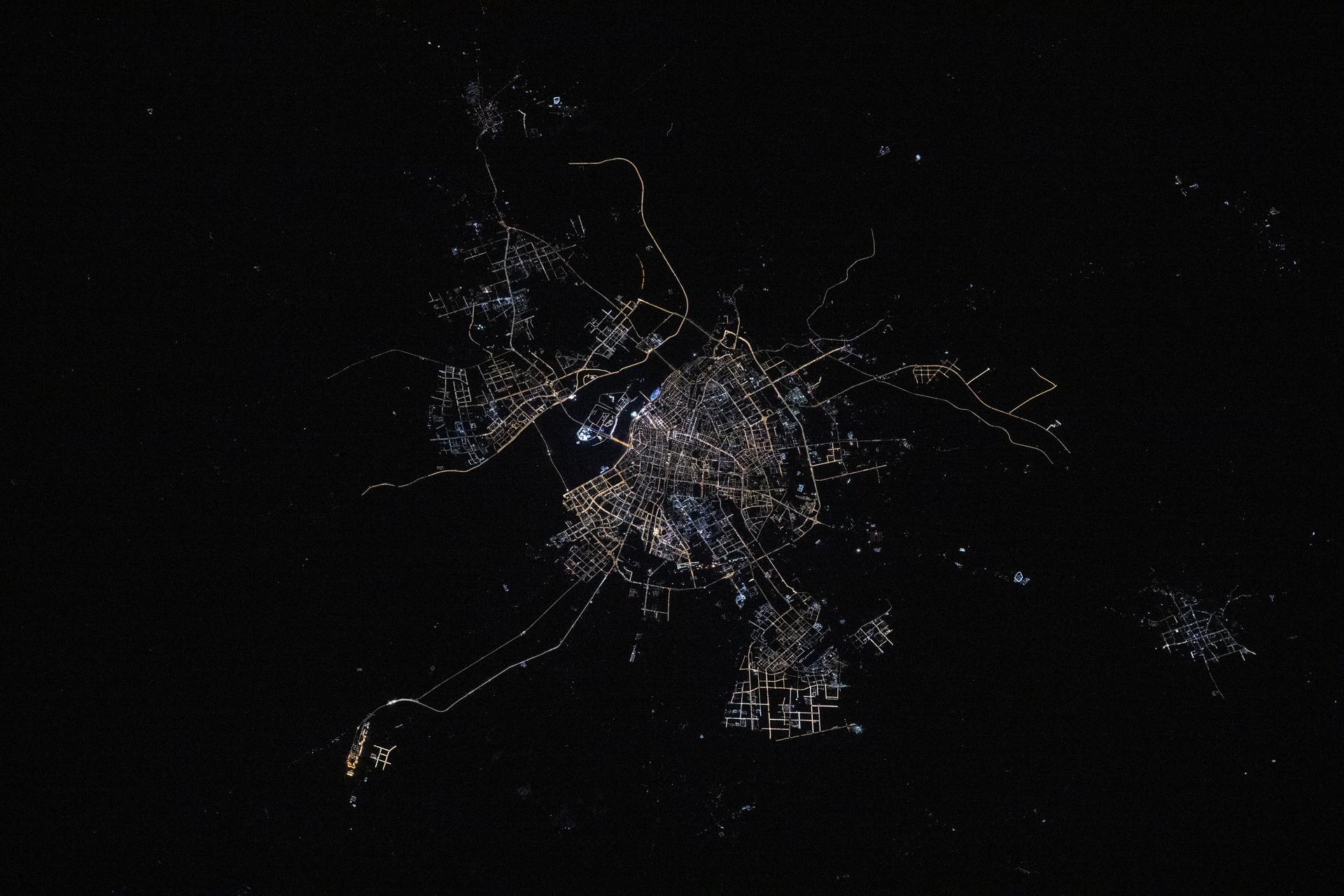 The city lights of Harbin, the capital of China's northernmost province of Heilongjiang with a population of about 10 million and split by the Songhua River, are pictured at approximately 1:33 a.m. local time from the International Space Station.