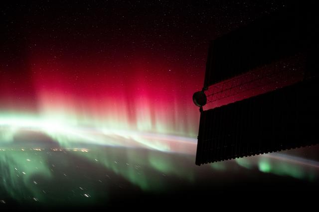 NASA image: A red and green aurora shimmers brightly above Ontario, Canada