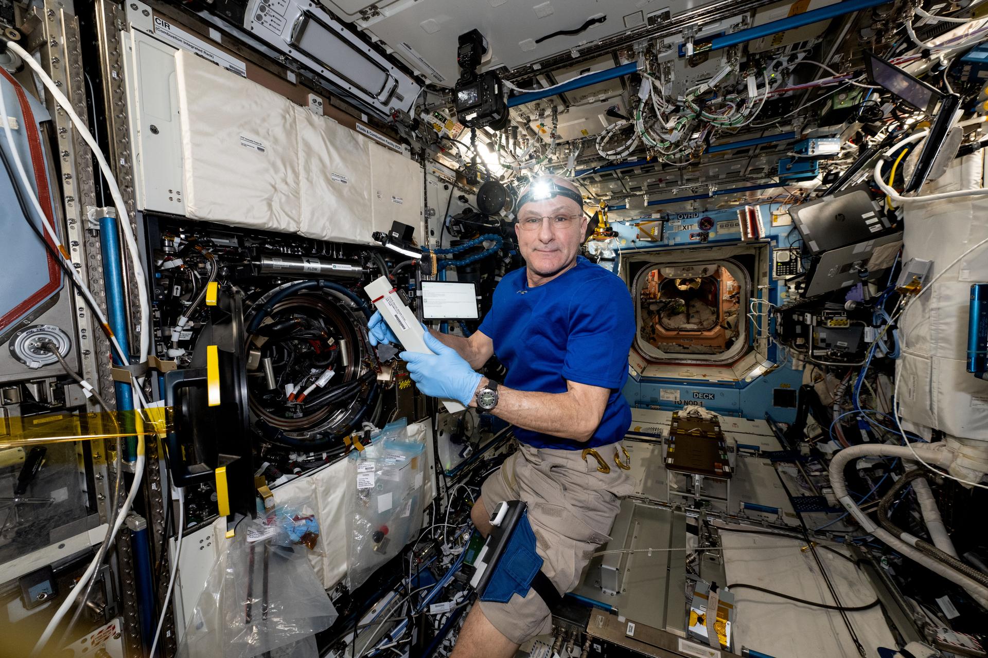 NASA astronaut and Expedition 72 Flight Engineer Don Pettit works in the Destiny laboratory module's Combustion Integrated Rack swapping samples of materials to observe how they burn in weightlessness. The investigation taking place inside the International Space Station's CIR enables the safe observation of flames and how they spread in microgravity potentially improving fire safety on crew missions.