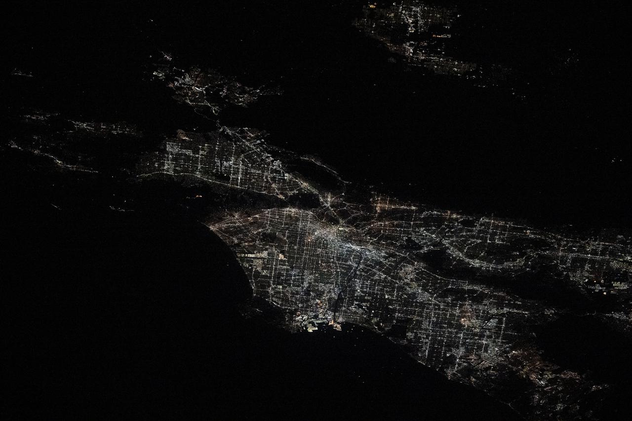 iss072e454582 (Jan. 10, 2024) --- City lights illuminate the Los Angeles, California, metropolitan area at approximately 2:30 a.m. local time as the Palisades, Hurst, and Eaton wildfires rage around nearby suburbs including Malibu, San Fernando, and Pasadena. The International Space Station was orbiting 258 miles above the southwestern United States at the time of this photograph. Credit: NASA/Don Pettit