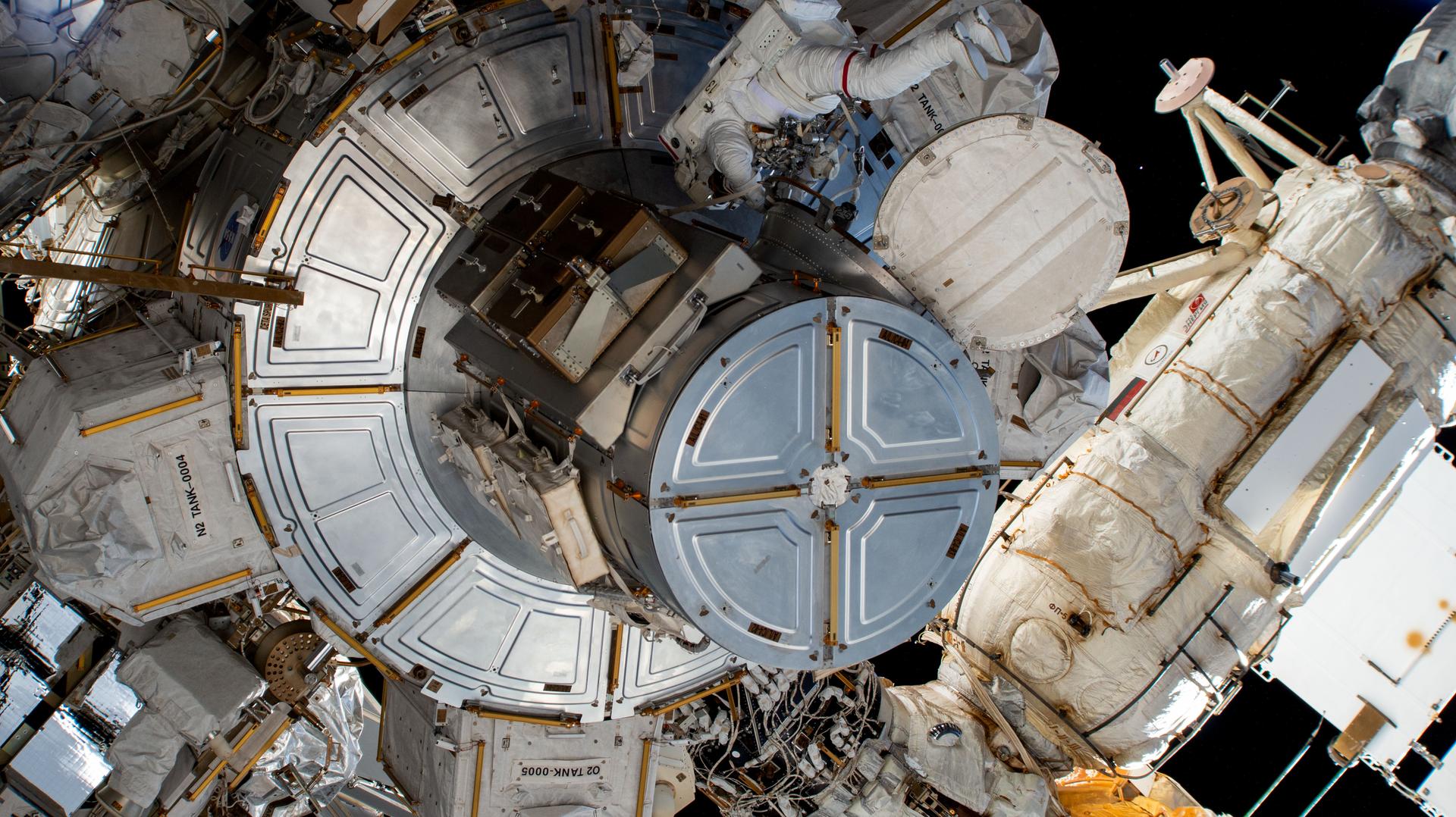 NASA astronaut and Expedition 72 Flight Engineer Nick Hague is pictured shortly after he exited the International Space Station's Quest airlock beginning a spacewalk to service astrophysics hardware including the NICER X-ray telescope and the Alpha Magnetic Spectrometer.