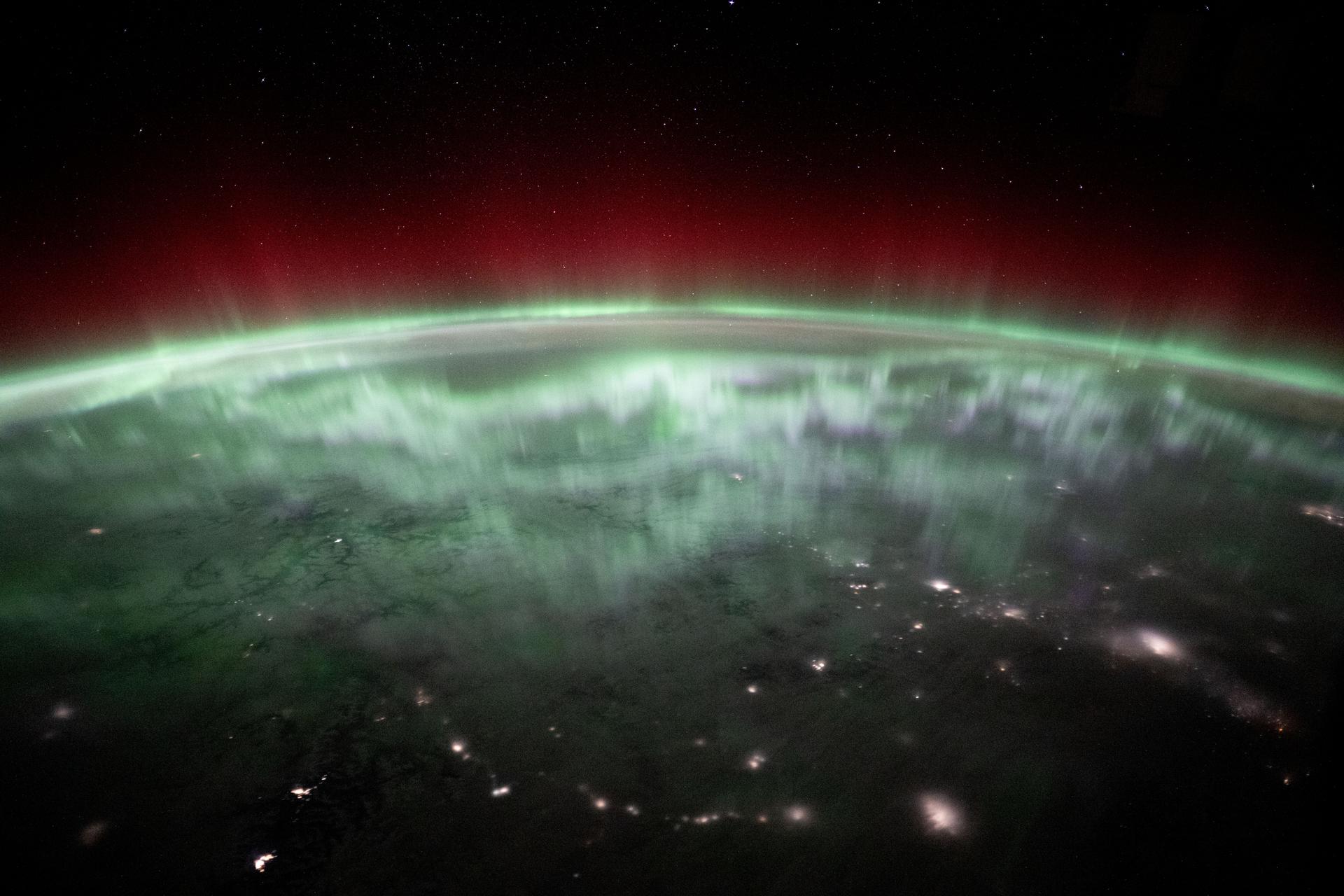 An aurora shimmers and dances above the city lights of Canada in this photograph from the International Space Station as it orbited 259 miles above Vancouver, British Columbia, about 1:55 a.m. local time. Credit: NASA/Don Pettit