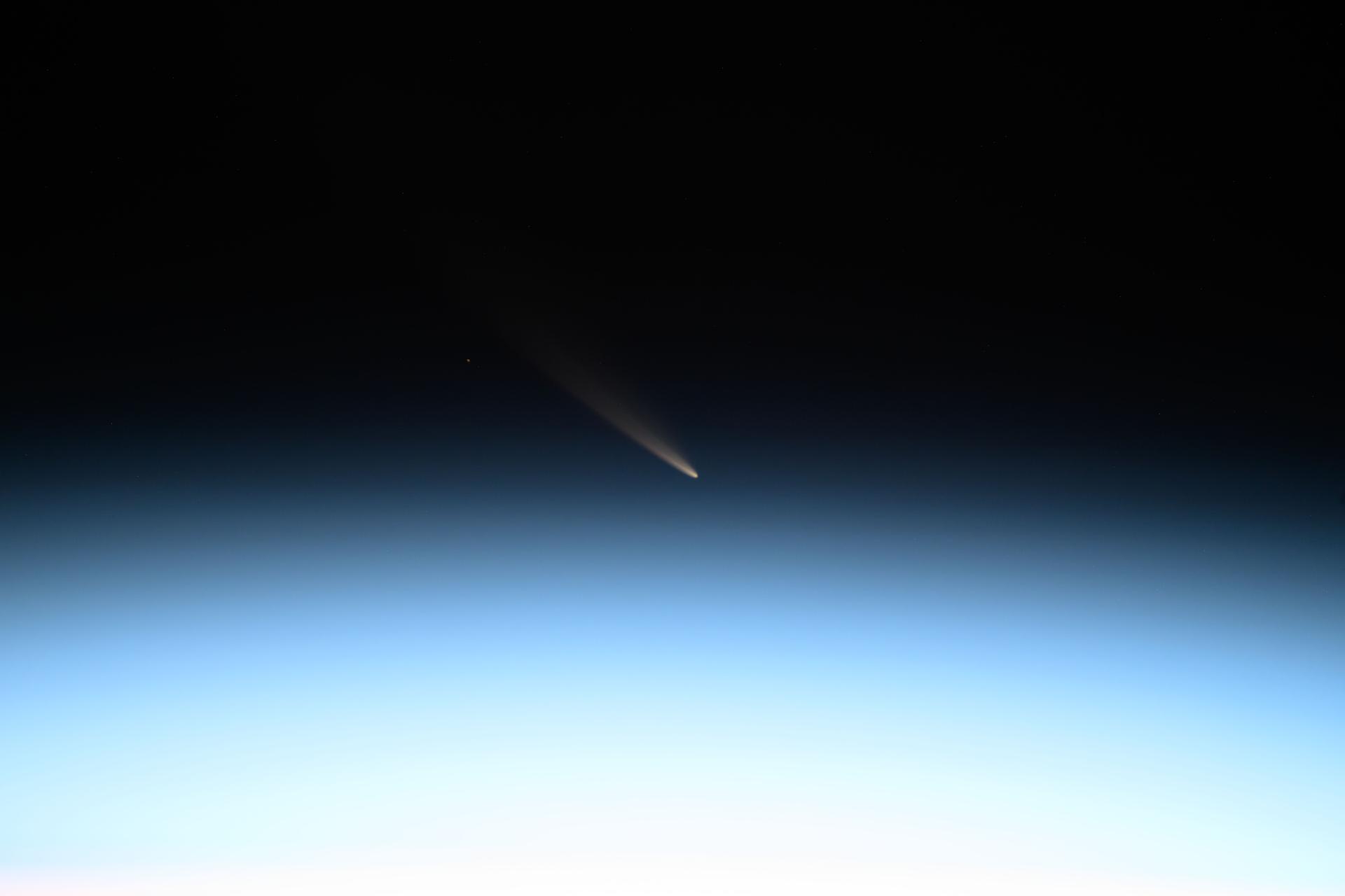 The non-periodic Comet C/2024 G3 (ATLAS), or the "Great Comet of 2025," is pictured seemingly above Earth's atmosphere though it was actually about 87 million miles away and five days past its closest approach, or perihelion, to the Sun. The International Space Station was orbiting 261 miles above Kazakhstan at the time of this photograph. Credit: NASA/Don Pettit