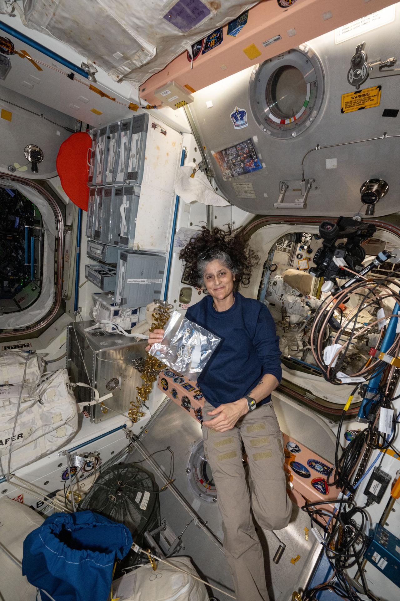 NASA astronaut and Expedition 72 Commander Suni Williams is pictured during maintenance activities inside the International Space Station's Unity module.