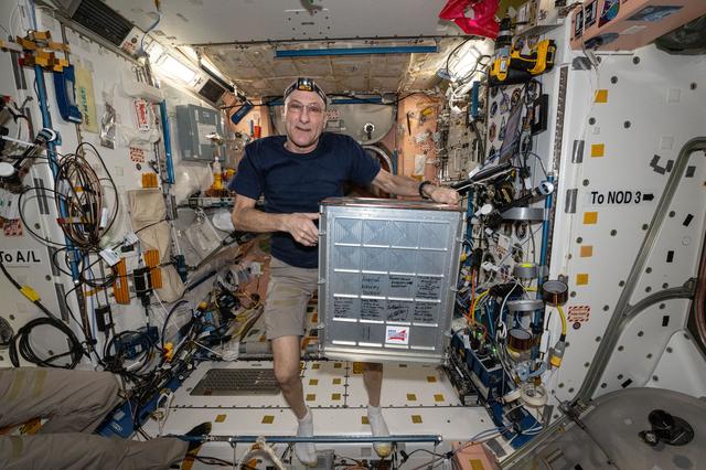 NASA image: Astronaut Don Pettit displays student-designed research gear