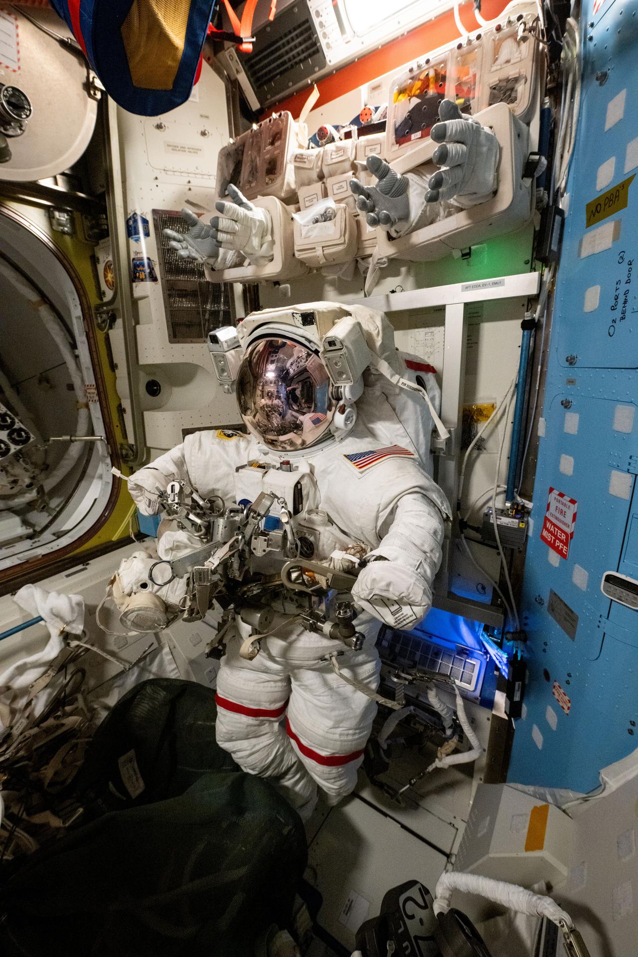 A spacesuit is pictured staged inside the International Space Station's Quest airlock ahead of a spacewalk planned for NASA astronauts Suni Williams and Butch Wilmore. The two spacewalkers are scheduled to exit the Quest airlock on Jan. 30 to remove a radio frequency group antenna assembly and search for microbes outside the orbital outpost.