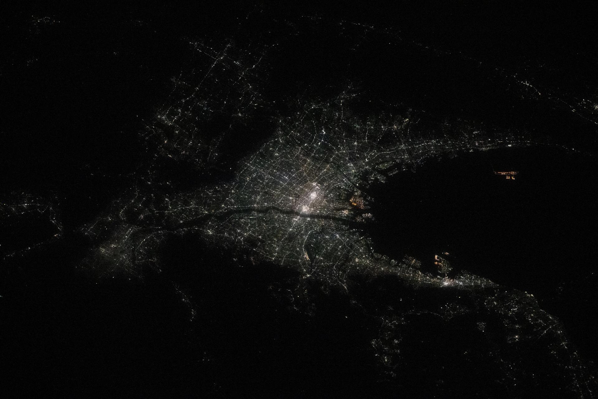 The city lights of Osaka, Japan, the island nation's third most populous city split by the Yodo River, are pictured at approximately 10:25 p.m. local time from the International Space Station as it orbited 258 miles above the Philippine Sea.