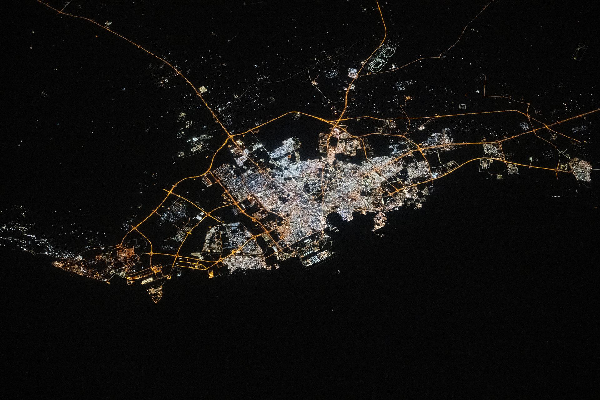 The city lights of Doha, Qatar, the Middle Eastern nation's capital with a population of about 1.2 million, are pictured at approximately 9:51 p.m. local time from the International Space Station as it orbited 258 miles above. Some prominent landmarks include the Shahaniyah Camel Race Track (top right), Hamad International Airport, and the artificial Pearl Island (both at center and on the Persian Gulf Coast).