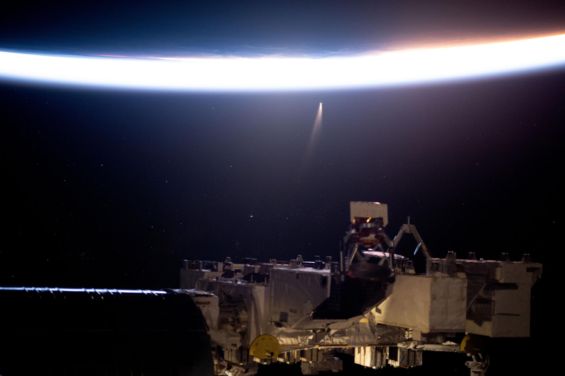 Comet C/2024 G3 (ATLAS) seems to be near Earth's horizon though it is over 305 million miles away in this photograph taken by NASA astronaut and Expedition 72 Flight Engineer Don Pettit. The International Space Station was orbiting into a sunrise 258 miles above the Pacific Ocean.