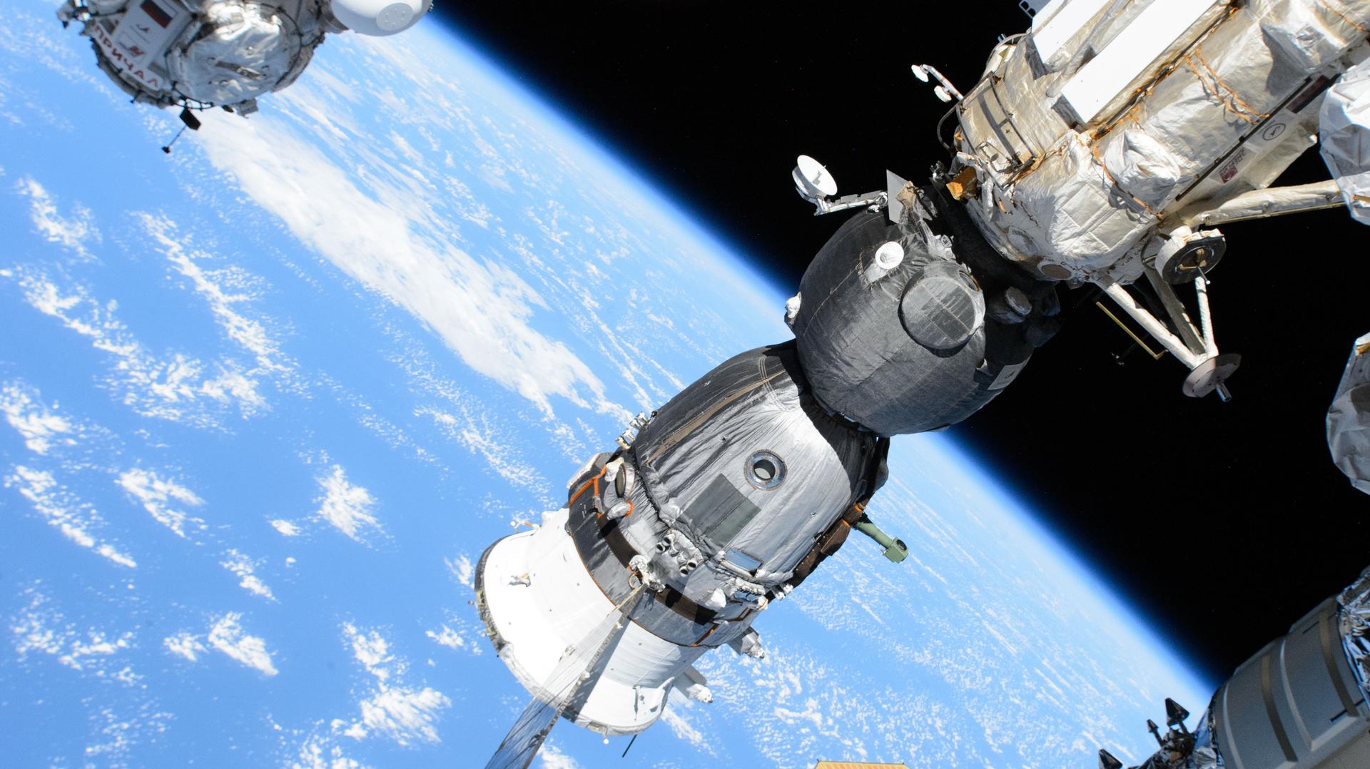 The Soyuz MS-26 crew ship that launched NASA astronaut Don Pettit and Roscosmos cosmonauts Alexey Ovchinin and Ivan Vagner to the International Space Station is pictured docked to the orbital outpost's Rassvet module.