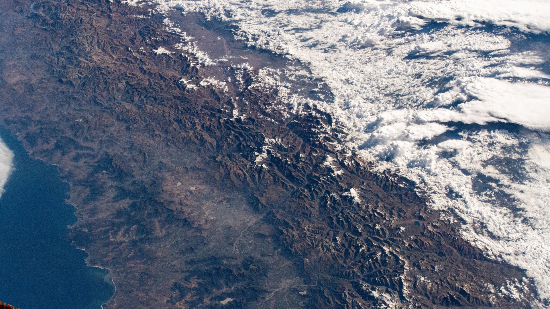 The Andes mountain range separates the South American nations of Chile and Argentina significantly impacting the climate of both countries. The elevation of the Andes creates a dry climate to the west and a rainy climate to the east. The International Space Station was orbiting 266 miles above Los Ángeles, Chile, at the time of this photograph.
