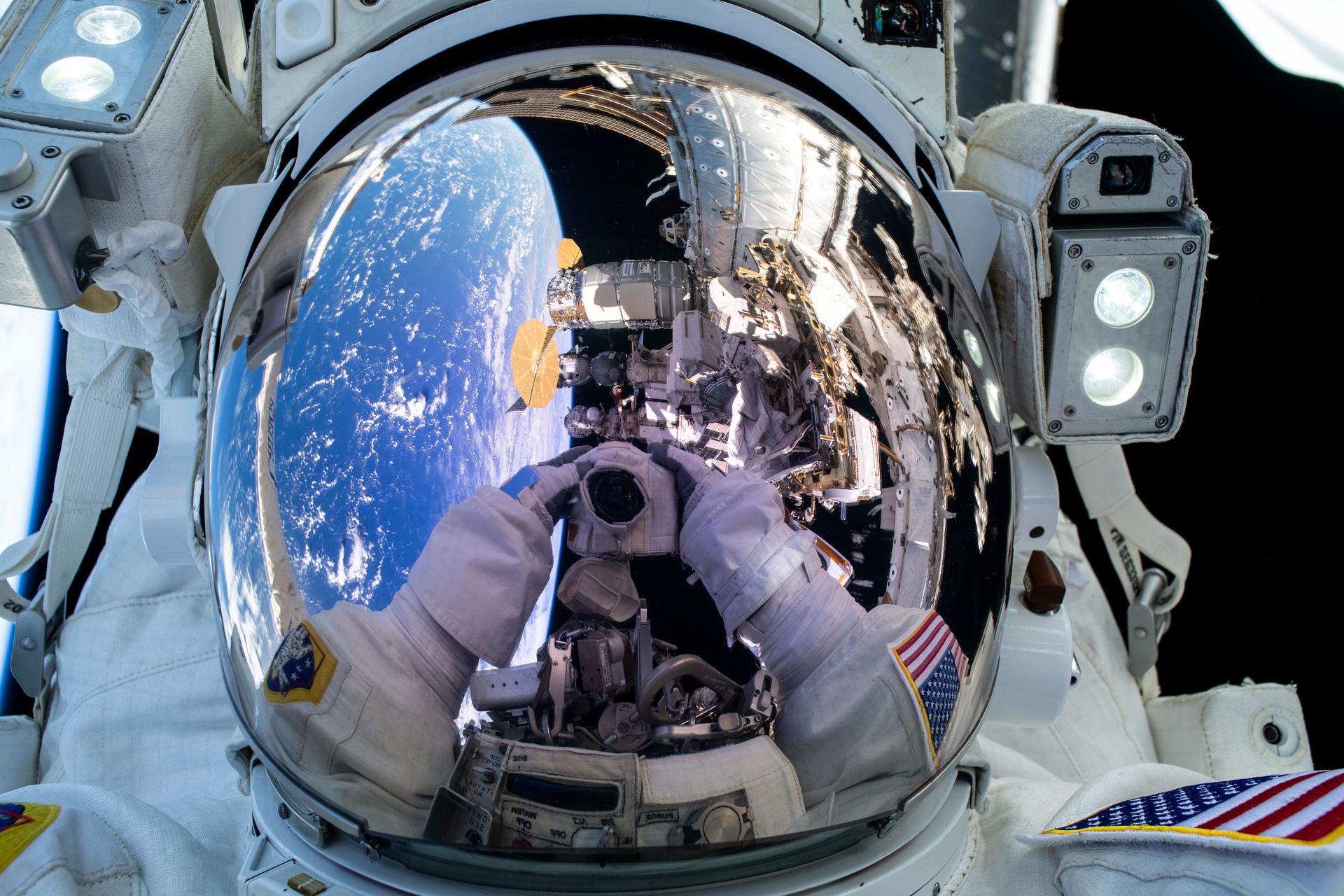 NASA astronaut and Expedition 72 Commander Suni Williams' camera is reflected in her spacesuit helmet's visor as she points it toward herself and takes an out-of-this-world "space-selfie" during a five-hour and 26-minute spacewalk. The International Space Station was orbiting 263 miles above the Pacific Ocean at the time of this photograph.