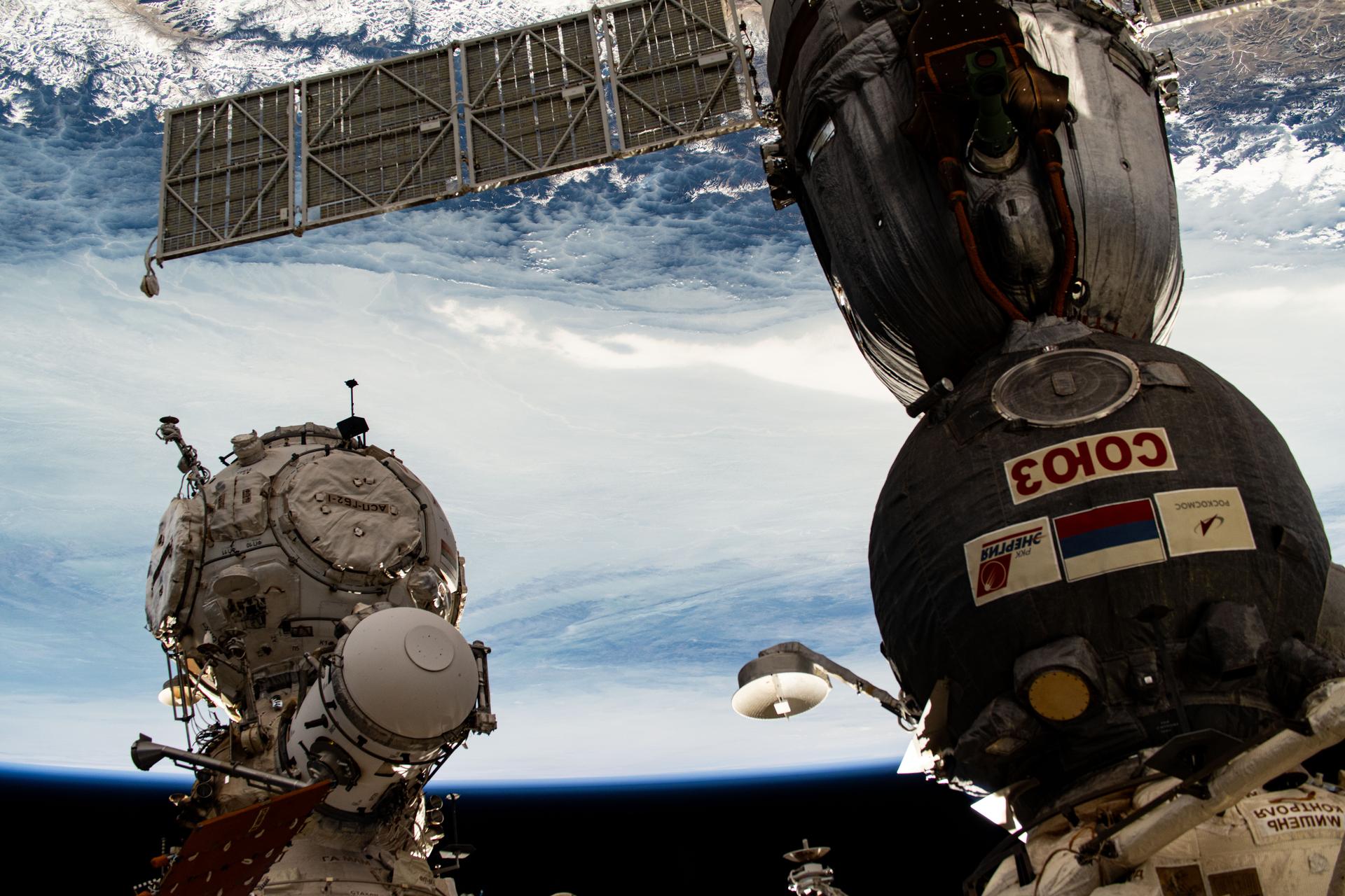 The Soyuz MS-26 crew ship that launched NASA astronaut Don Pettit and Roscosmos cosmonauts Alexey Ovchinin and Ivan Vagner to the International Space Station is pictured docked to the orbital outpost's Rassvet module. At left, is the Pirs docking compartment where Soyuz crew ships and Progress cargo craft can also dock.