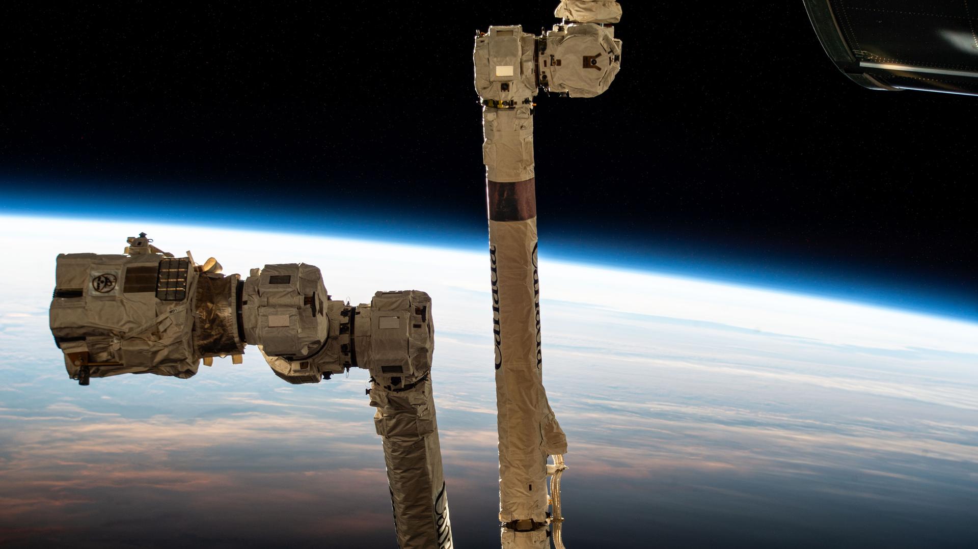 The 57.7-foot-long Canadarm2 robotic arm with its latching end effector that can grapple spacecraft or maneuver spacewalkers is pictured as the International Space Station orbited into daylight 267 miles above the South Pacific Ocean just south of New Zealand's Auckland Islands.