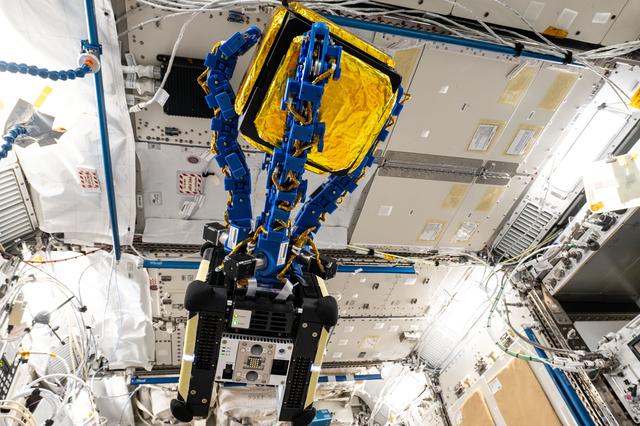 NASA image: An Astrobee robotic free-flyer with blue tentacle-like arms