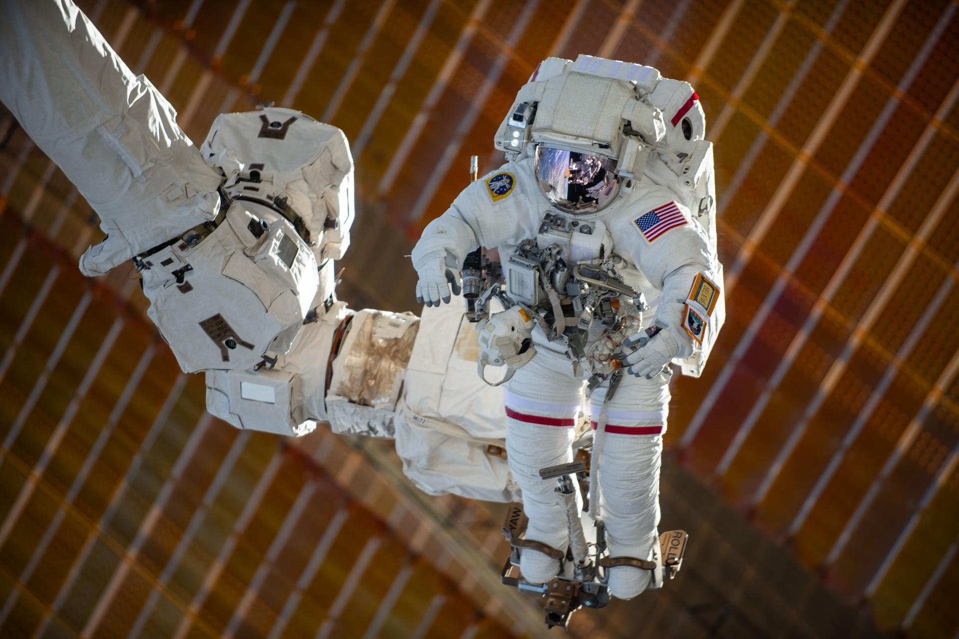 NASA astronaut and Expedition 72 Commander Suni Williams is attached to the Canadarm2 robotic arm's latching end effector while being maneuvered to her worksite 264 miles above the South Pacific Ocean. Williams removed and stowed a radio frequency group antenna assembly during the five-hour and 26-minute spacewalk outside the International Space Station.