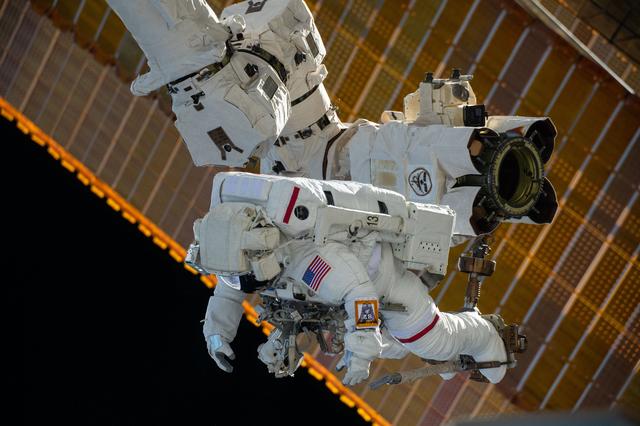 NASA image: Astronaut is attached to the Canadarm2 robotic arm's latching end effector