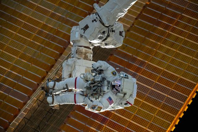 NASA image: Astronaut is attached to the Canadarm2 robotic arm's latching end effector