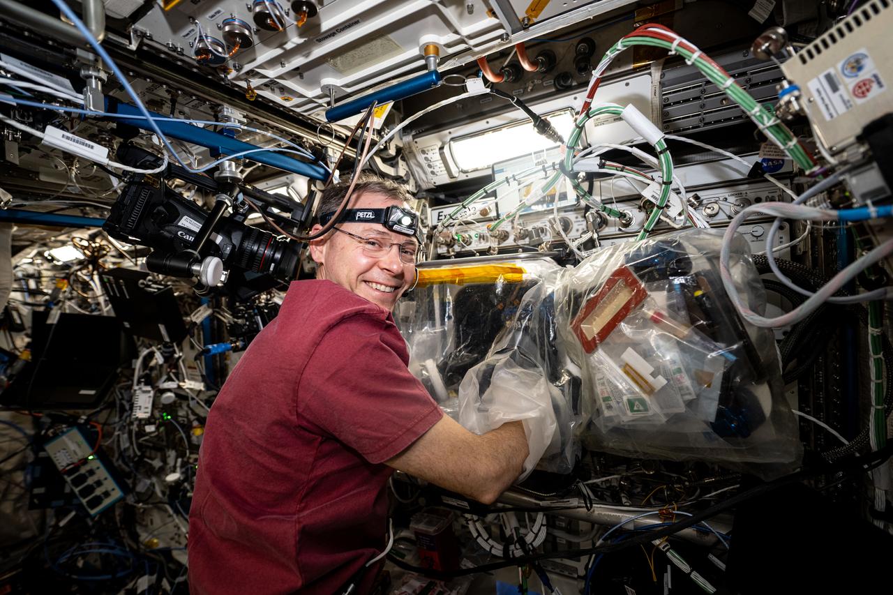 iss072e629194 (Feb. 18, 2025) --- NASA astronaut and Expedition 72 Flight Engineer Nick Hague works in a portable glovebag and cleans pumps, replaces components, and installs bio-ink syringes inside the BioFabrication Facility being tested for its capability to print biological, or organ-like, tissues in space and learn how to eventually fabricate human organs off the Earth.