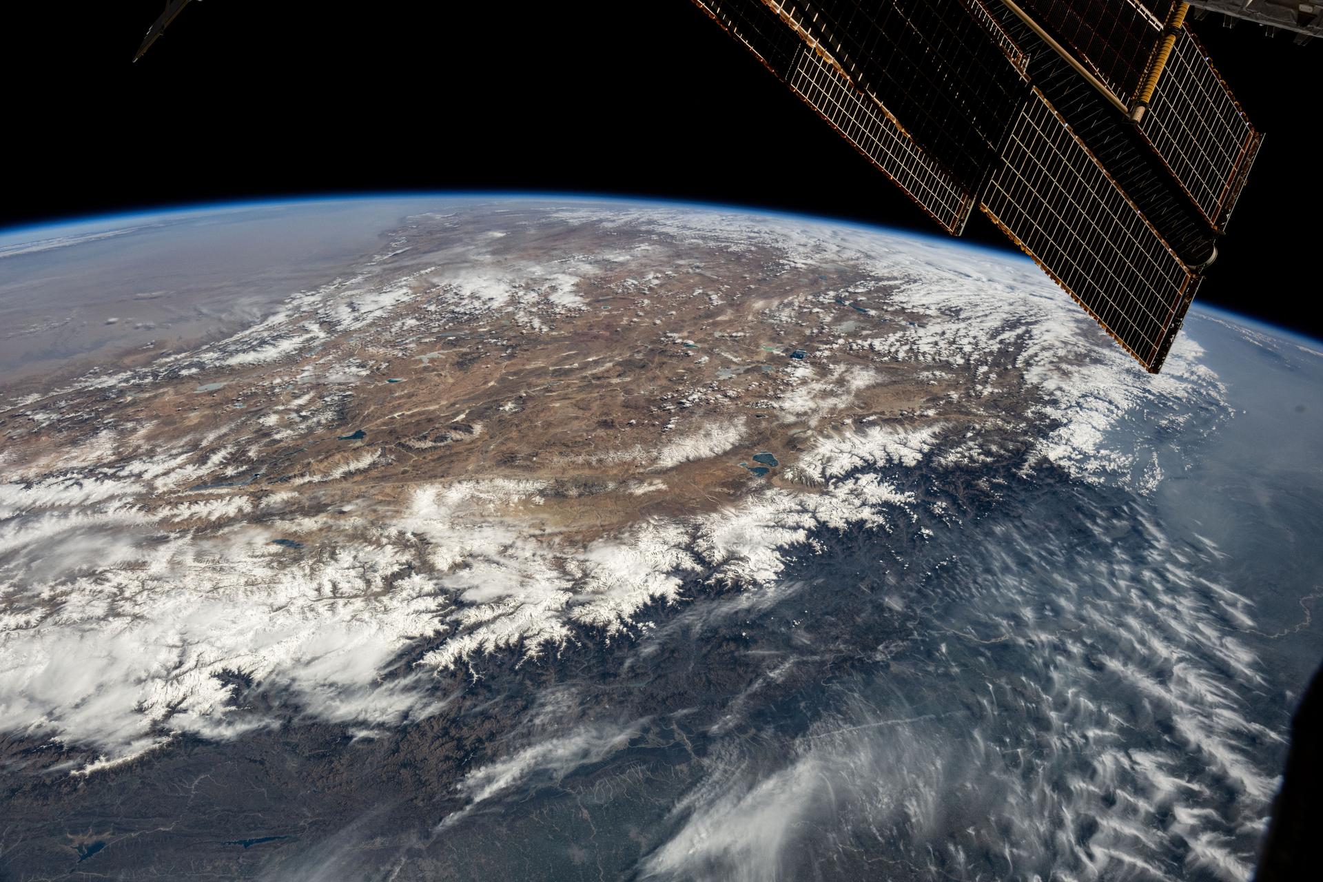 The Himalayas separate China in the north from India in the south affecting the climate in both regions in this photograph from the International Space Station as it orbited 261 miles above. The mountain chain blocks moisture and cool air from the south leading to heavy rainfall on the Indian subcontinent while creating arid conditions to the north in China's Tibetan Plateau.