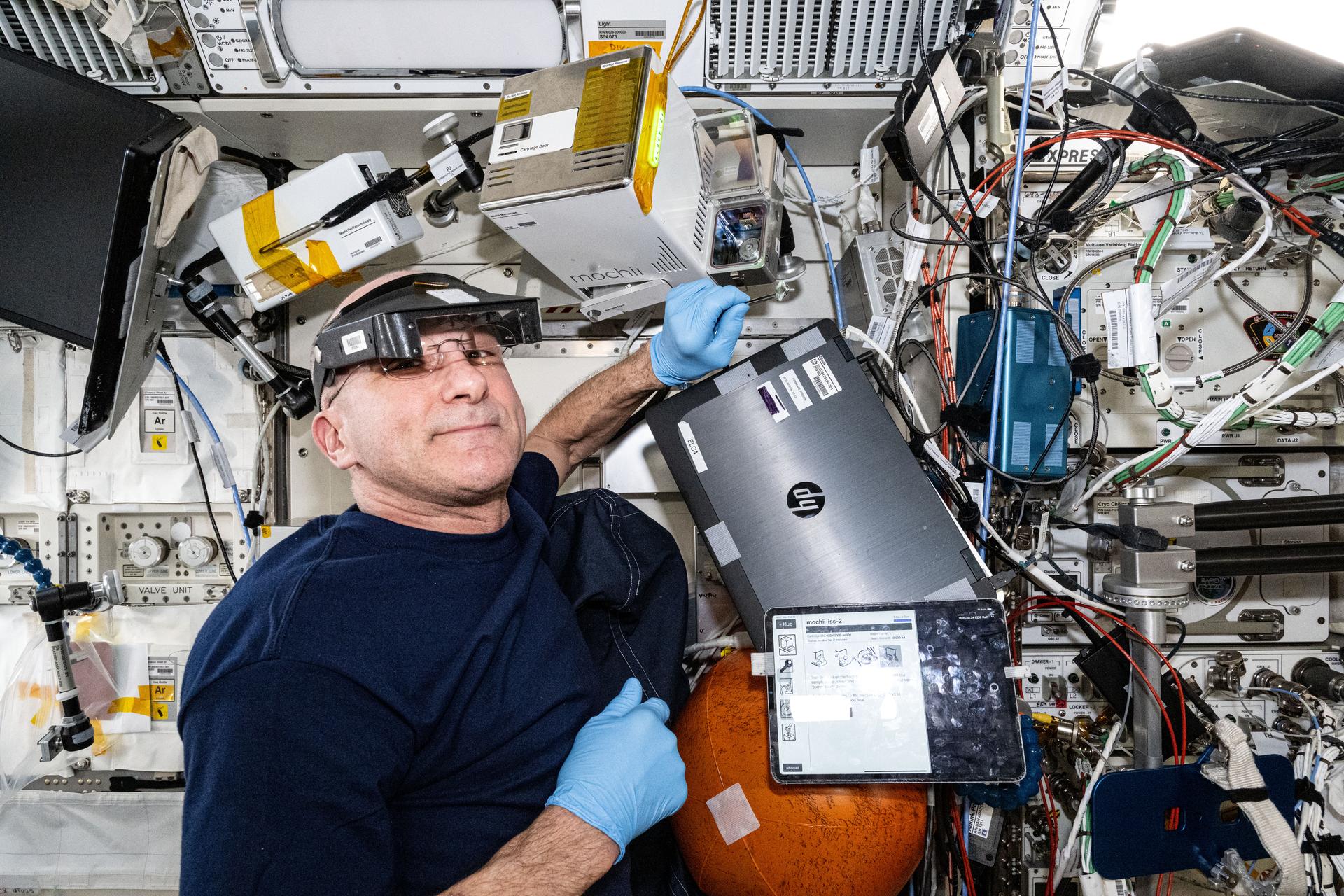 NASA astronaut and Expedition 72 Flight Engineer Don Pettit processes samples for imaging operations inside the Mochii miniature electron scanning microscope. Mochii, located inside the International Space Station's Kibo laboratory module, may help crews rapidly identify particles that are hazardous to crew health and spacecraft systems without relying on time-consuming missions to return the samples to Earth for analysis.