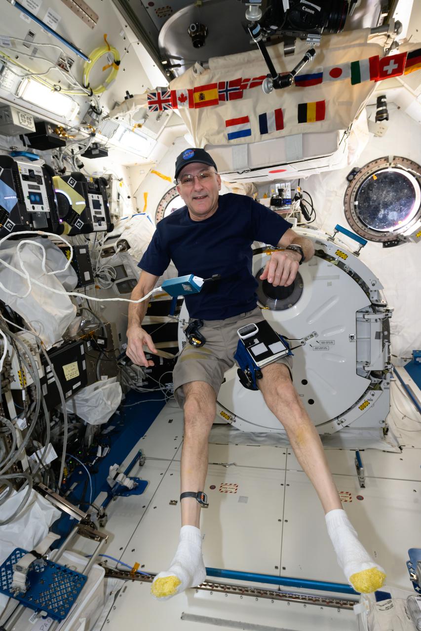 iss072e661836 (Feb. 28, 2025) --- NASA astronaut and Expedition 72 Flight Engineer Don Pettit poses for a portrait inside the International Space Station's Kibo laboratory module. Attached to Pettit's legs are a notebook and a variety of tools used for research and maintenance operations aboard the orbital outpost.