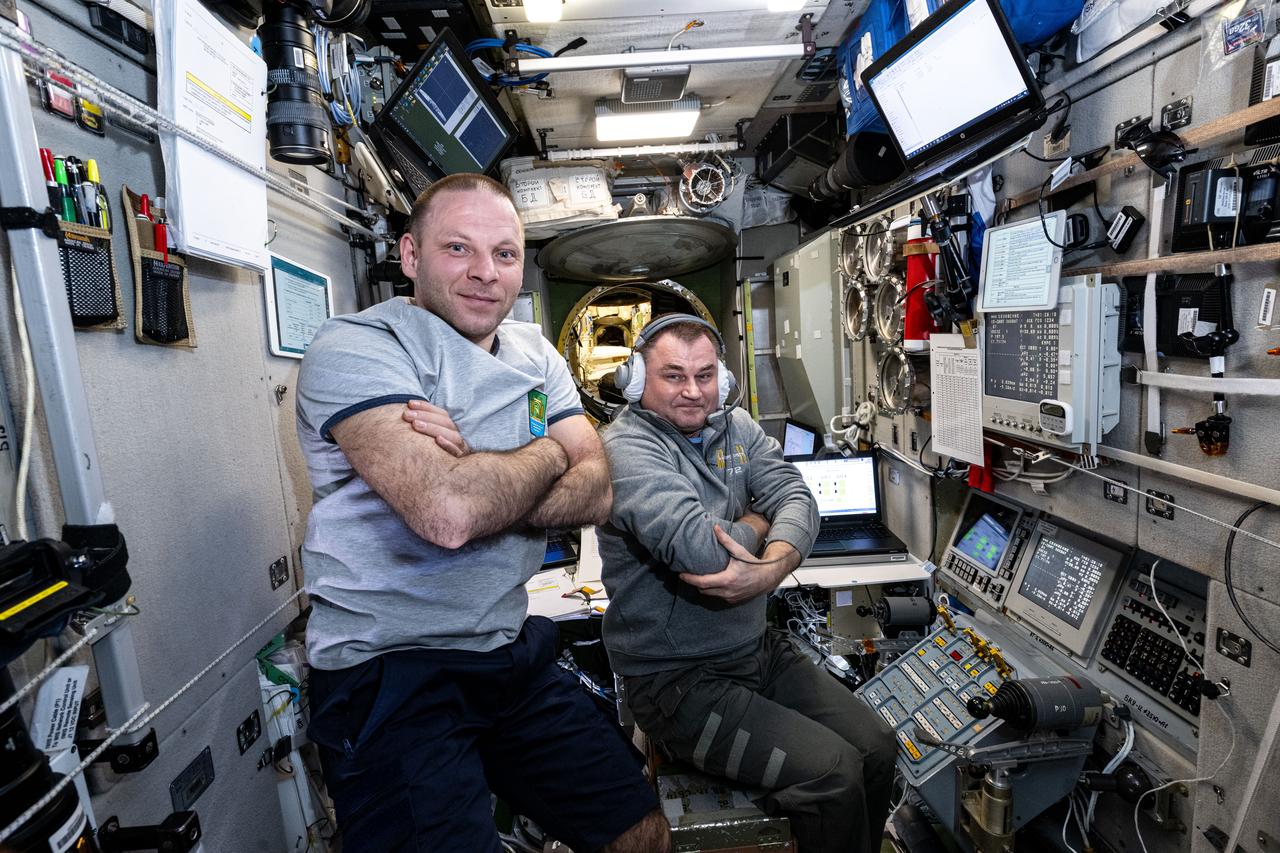 iss072e742446 (March 1, 2025) --- Roscosmos cosmonauts (from left) Ivan Vagner and Alexey Ovchinin, both Expedition 72 flight engineers, are pictured at the controls of the telerobotically operated rendezvus unit, or TORU, located inside the International Space Station's Zvezda service module. The cosmonauts were monitoring the automated approach and docking of the Progress 91 cargo craft carrying nearly three tons of food, fuel, and supplies for the orbital residents. The TORU would be used to remotely control an approaching spacecraft, if necessary, though unlikely.