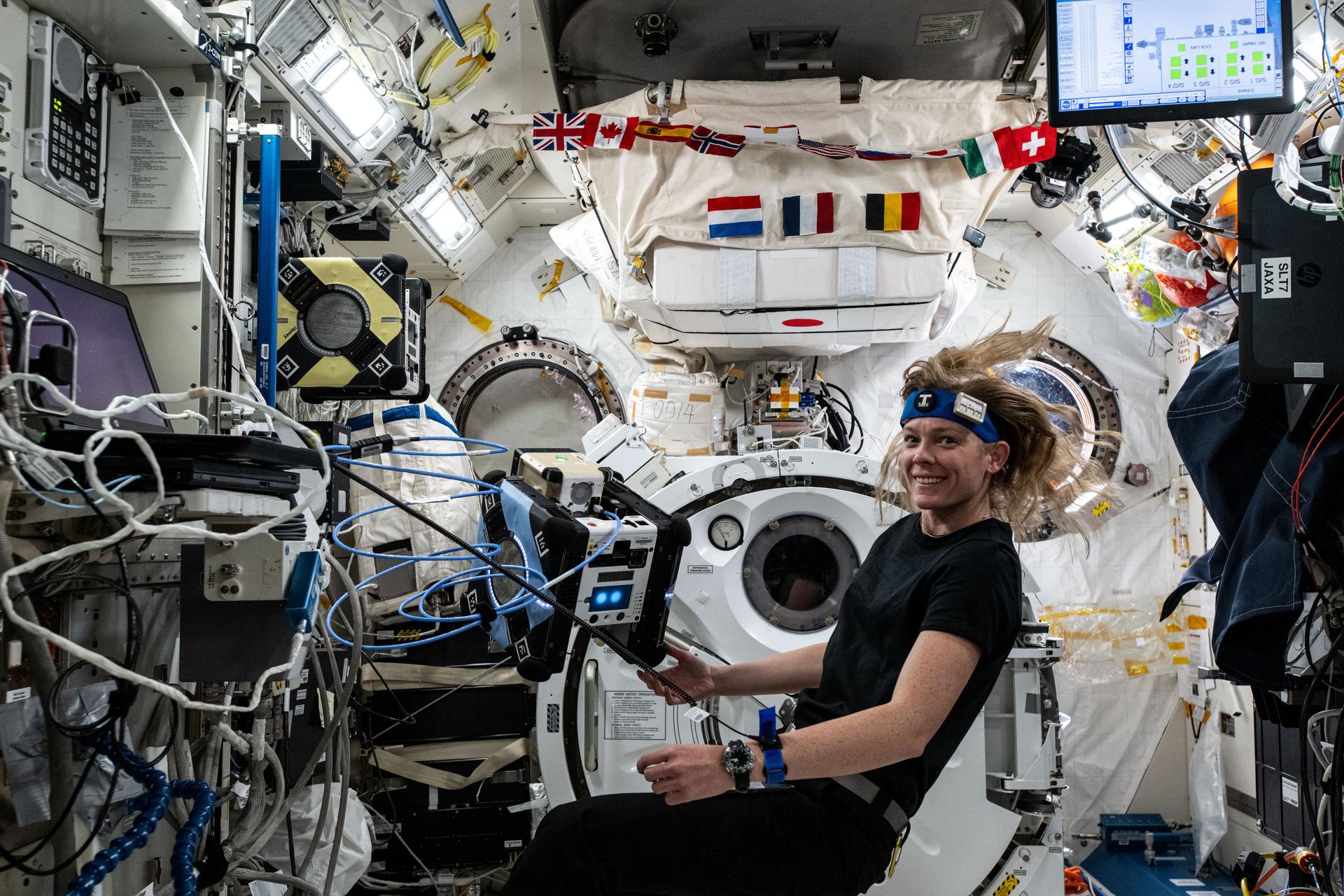 NASA astronaut and Expedition 72 Flight Engineer Nichole Ayers works inside the International Space Station's Kibo laboratory module loading software onto an Astrobee robotic free-flyer. The software is part of a technology investigation demonstrating an adaptor for docking and close approach sensing to connect both active and passive objects in space. Results may enable applications such as satellite servicing, orbital refueling, spacecraft repair and upgrade, and in-orbit manufacturing.
