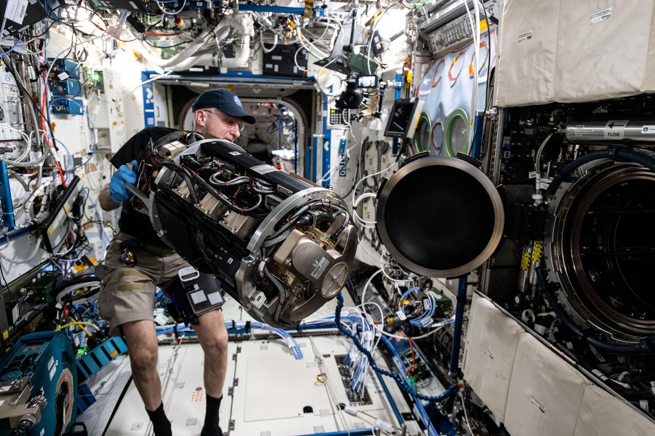iss072e747148 (March 18, 2025) --- NASA astronaut and Expedition 72 Flight Engineer Don Pettit inserts research hardware into the Combustion Integrated Rack located inside the International Space Station's Destiny laboratory module. Pettit was configuring the SoFIE-MIST, or the Solid Fuel Ignition and Extinction - Material Ignition and Suppression Test, investigation that is exploring the flammability of materials in microgravity to improve spacecraft fire safety.