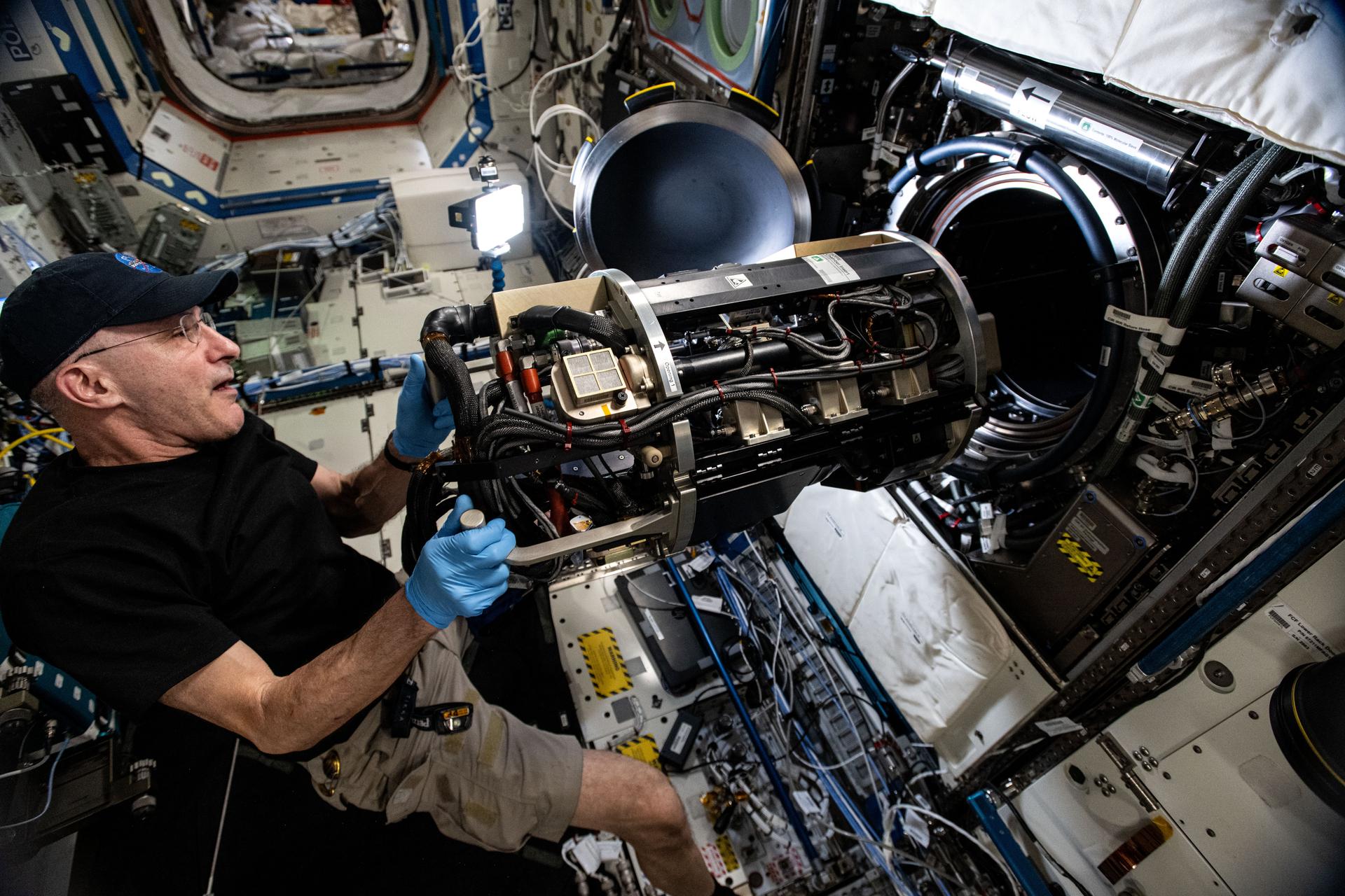 NASA astronaut and Expedition 72 Flight Engineer Don Pettit inserts research hardware into the Combustion Integrated Rack located inside the International Space Station's Destiny laboratory module. Pettit was configuring the SoFIE-MIST, or the Solid Fuel Ignition and Extinction - Material Ignition and Suppression Test, investigation that is exploring the flammability of materials in microgravity to improve spacecraft fire safety.