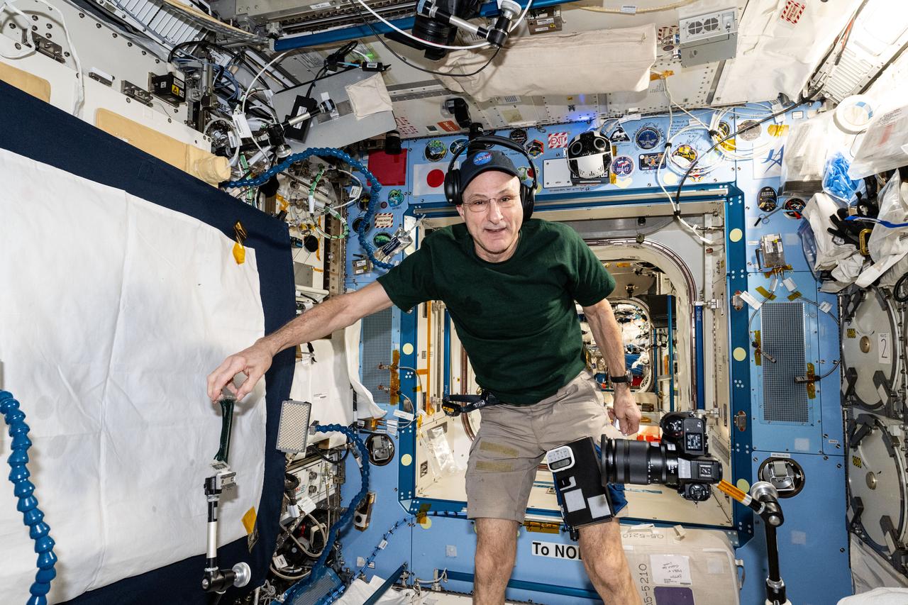iss072e782399 (March 15, 2025) --- NASA astronaut and Expedition 72 Flight Engineer Don Pettit sets up camera hardware to photograph research activities inside the International Space Station's Kibo laboratory module.