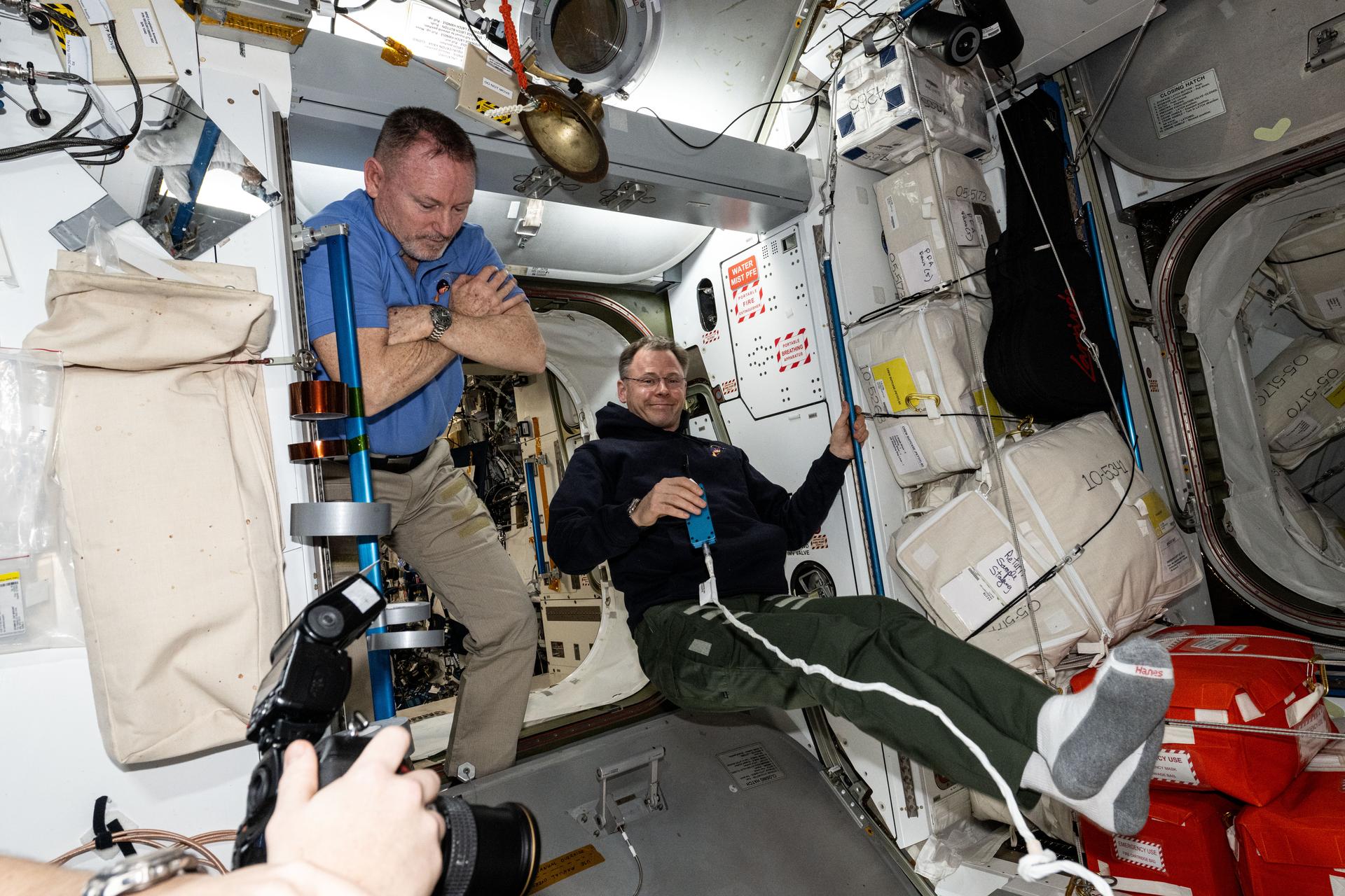NASA astronauts (from left) Butch Wilmore and Nick Hague, both Expedition 72 Flight Engineers, are pictured relaxing inside the International Space Station's Harmony module.