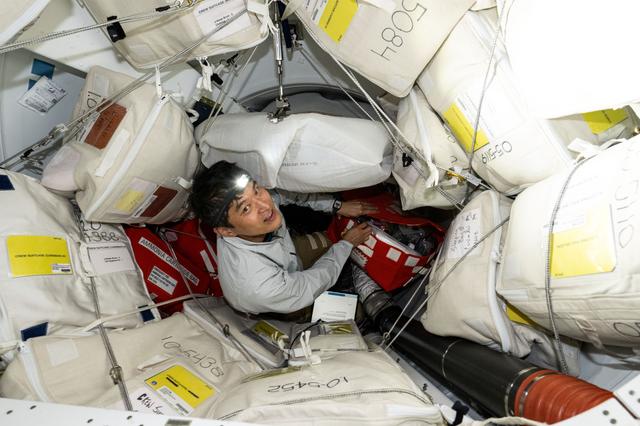 NASA image: JAXA astronaut Takuya Onishi unpacks cargo stowed inside Dragon