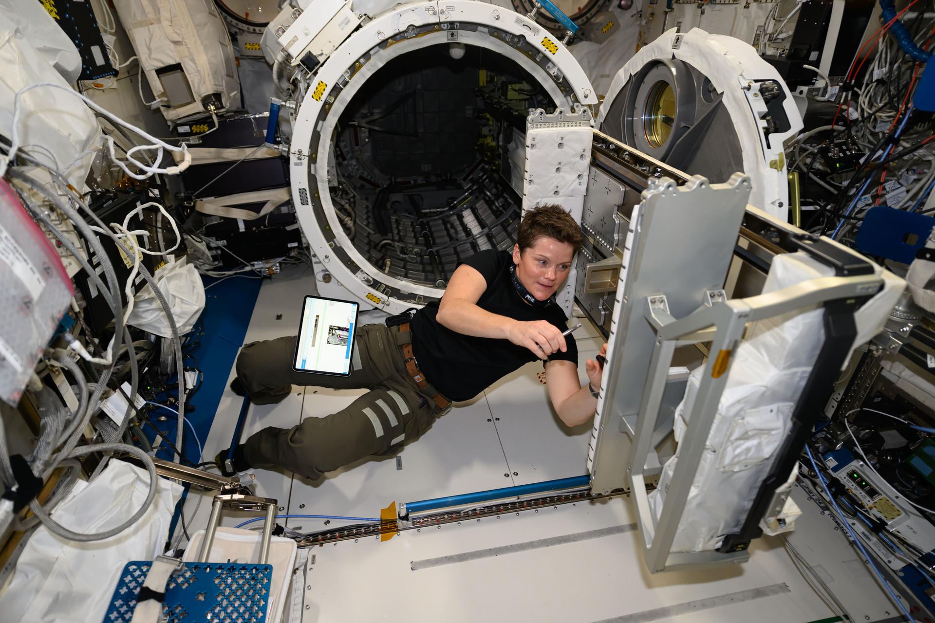 NASA astronaut and Expedition 72 Flight Engineer Anne McClain works on hardware maintenance tasks inside the International Space Station's Kibo laboratory module. Behind McClain is Kibo's airlock where experiment hardware such as external exposure investigations and CubeSats are staged before being placed outside the orbiting lab into the vacuum of space.