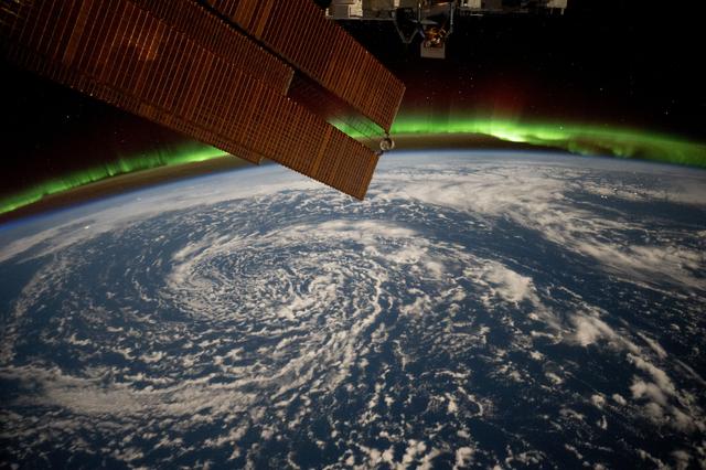 NASA image: Clouds swirl over the Gulf of Alaska and underneath the aurora borealis