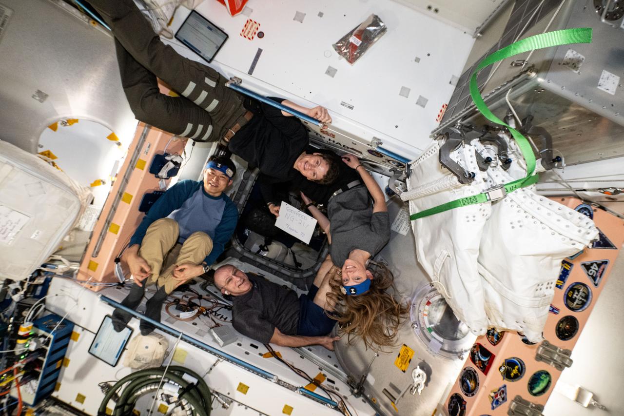 iss072e861347 (March 28, 2025) --- Clockwise from left, are Expedition 72 Flight Engineers Takuya Onishi from JAXA (Japan Aerospace Exploration Agency) and Anne McClain, Nichole Ayers, and Don Pettit, all three from NASA. The quartet is posing inside the vestibule between the International Space Station's Unity module and the Cygnus space freighter that would depart the orbital outpost soon after this photograph was taken.