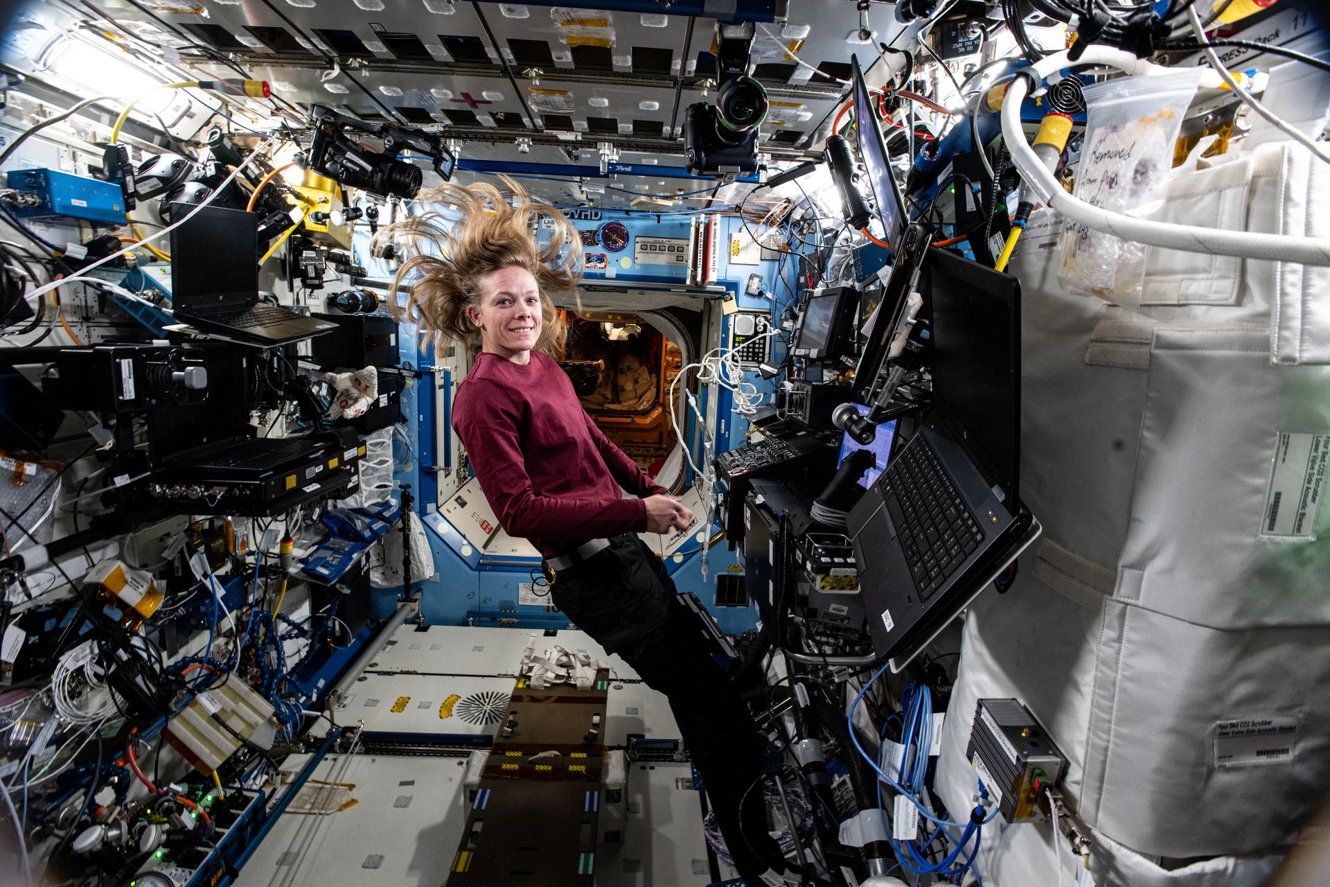 NASA astronaut and Expedition 72 Flight Engineer Nichole Ayers is pictured at the controls of the robotics workstation in the International Space Station's Destiny laboratory module. Ayers was monitoring the release of the Northrop Grumman Cygnus cargo craft from the grips of the Canadarm2 robotic arm ending a seven-and-a-half-month mission at the orbital lab.