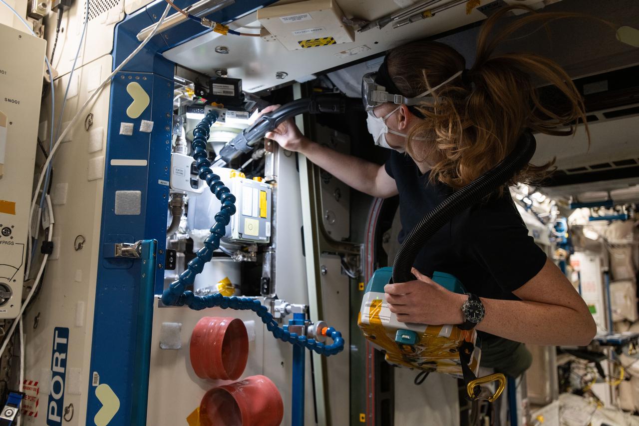 iss072e919611 (April 2, 2025) --- NASA astronaut and Expedition 72 Flight Engineer Nichole Ayers cleans ventilation system fans and inlets inside the International Space Station's Destiny labortory module.