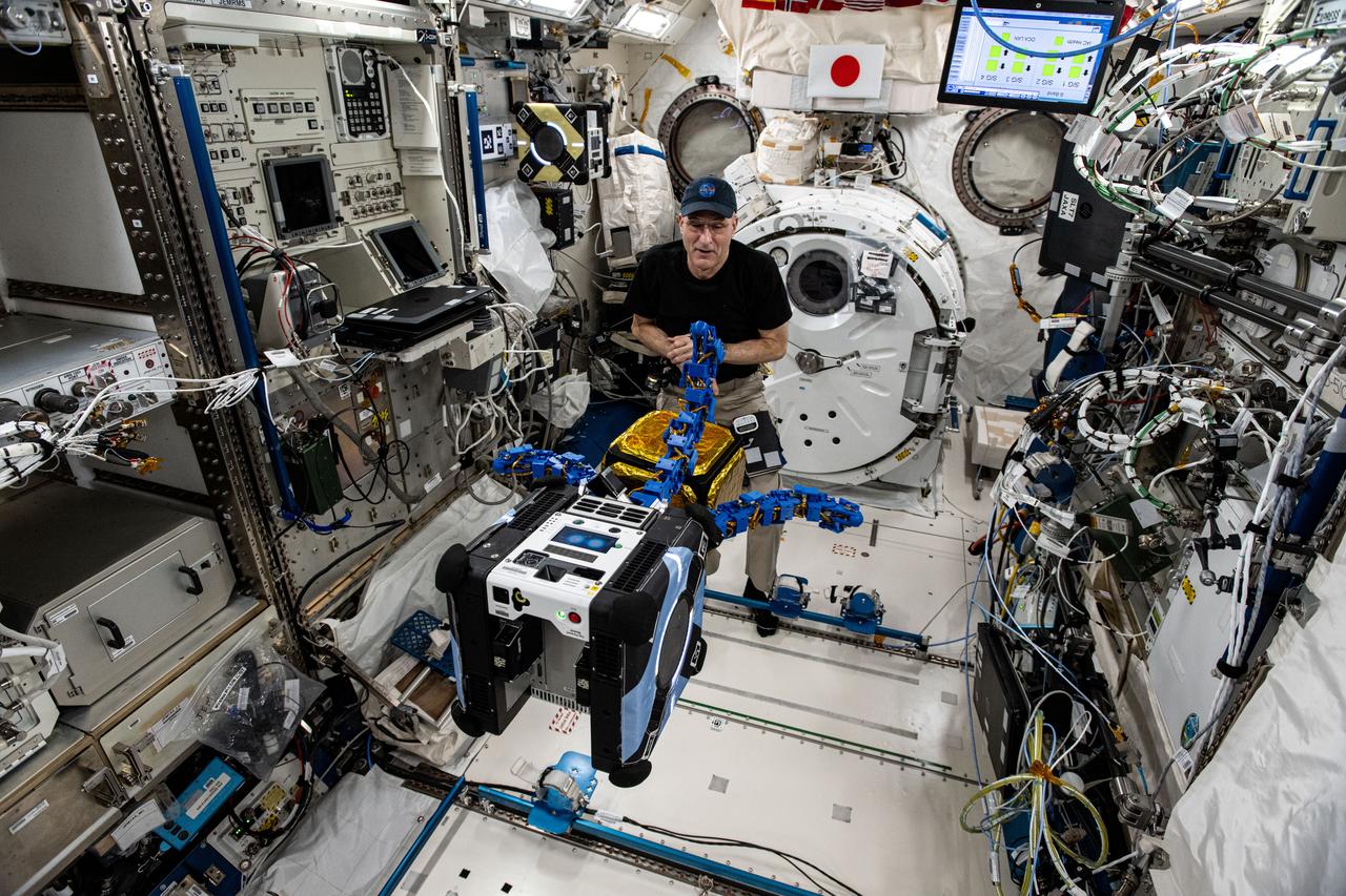 iss072e921201 (April 4, 2025) --- NASA astronaut and Expedition 72 Flight Engineer Don Pettit watches as an Astrobee robotic free-flyer outfitted with tentacle-like grippers grapples a "capture cube" inside the International Space Station's Kibo laboratory module.
